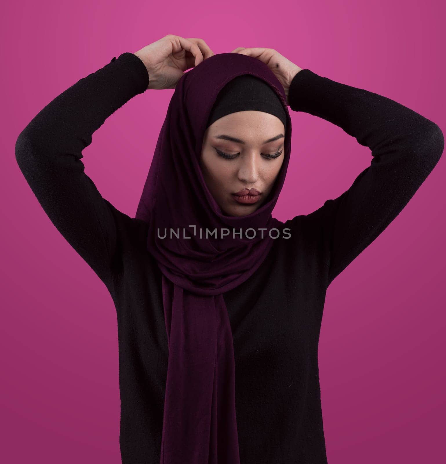 Modern Muslim woman wearing stylish hijab casual wear isolated on pink background. Diverse people model hijab fashion concept. by dotshock