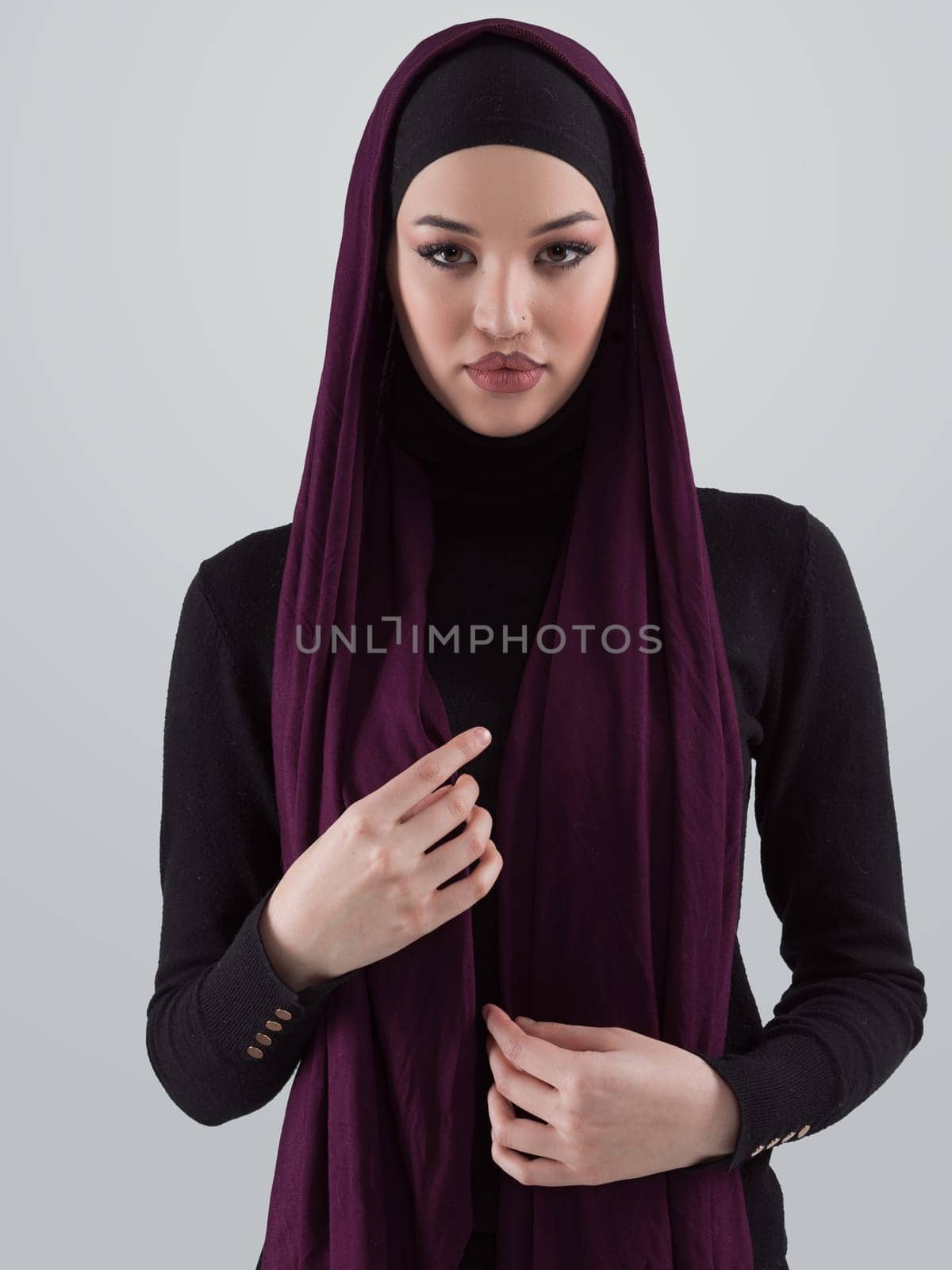 Muslim woman wearing modern stylish wear and hijab isolated on grey background. Diverse people model hijab fashion concept. High quality photo