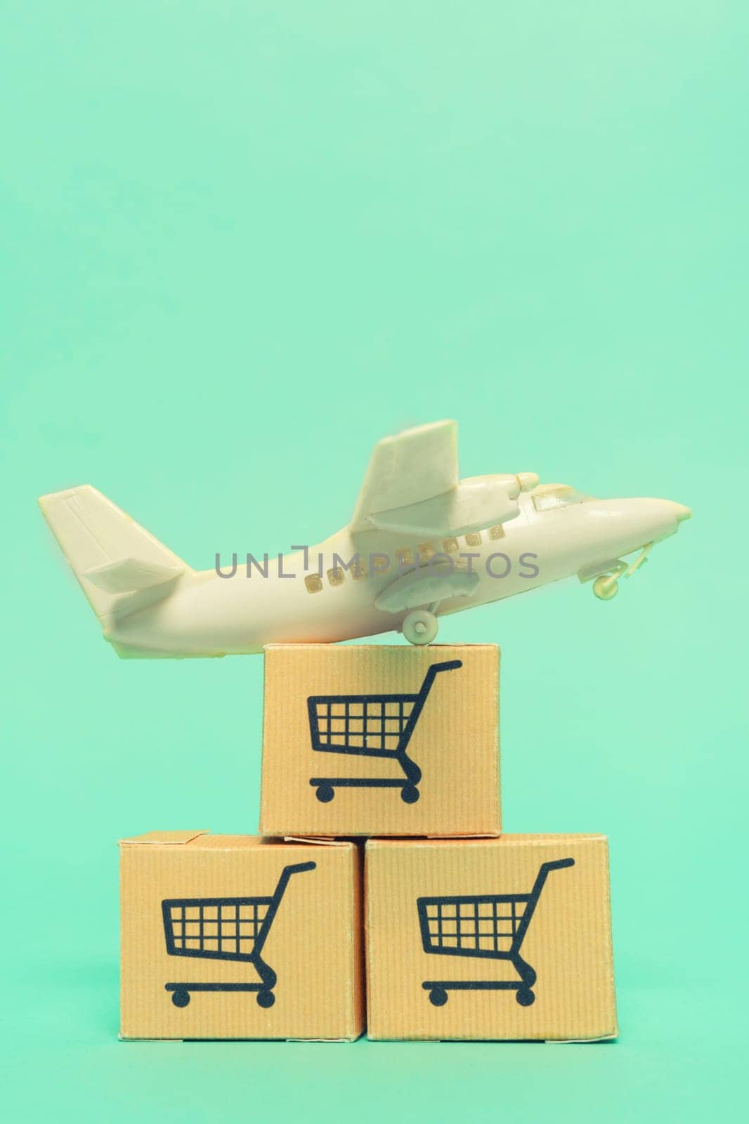 White model airplane lands on blue background from most famous countries around the world with boxes of goods behind. An idea of air freight transportation, global parcel forwarding, international shipping