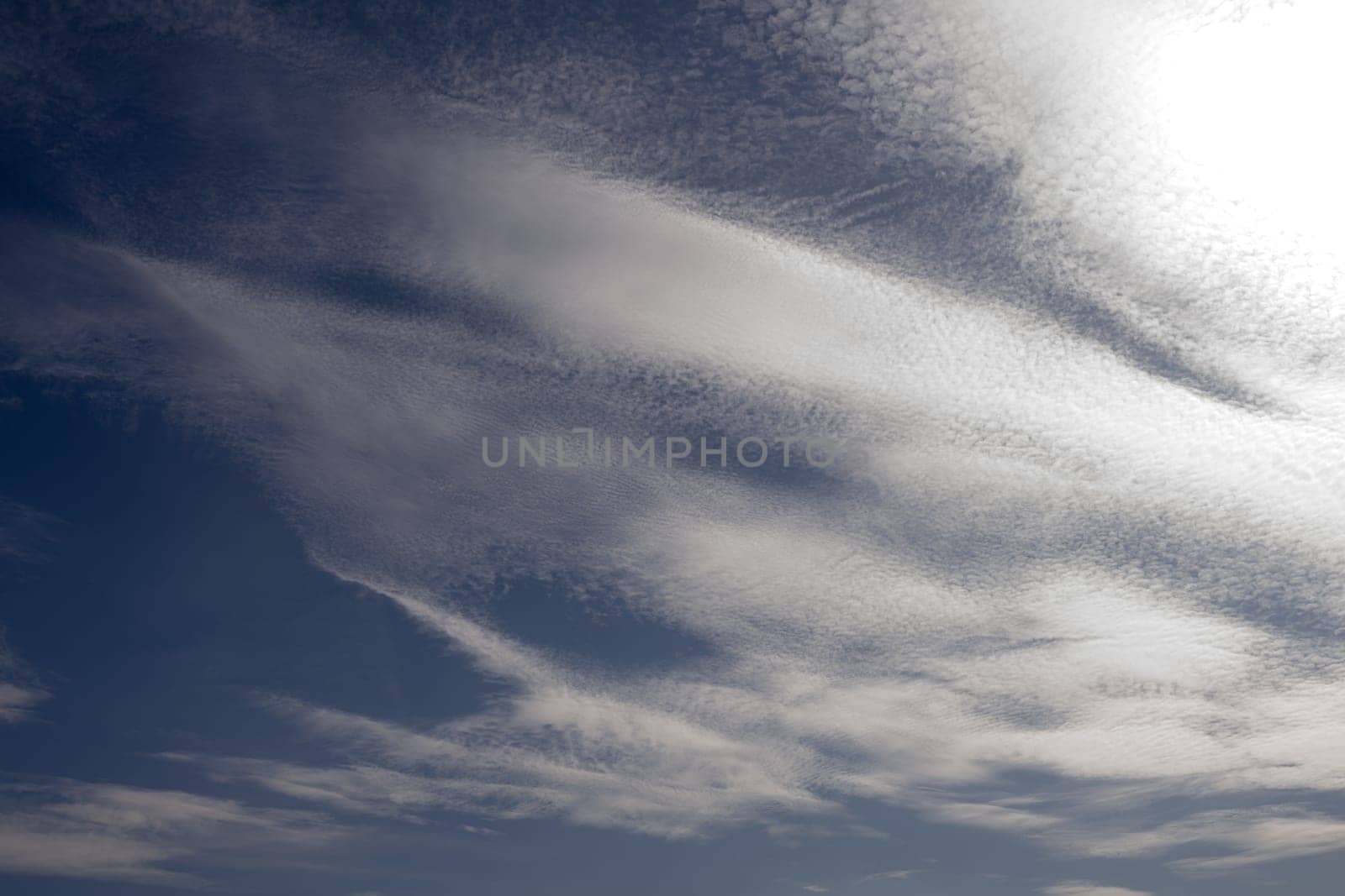 White spindrift clouds on blue sky, background - image