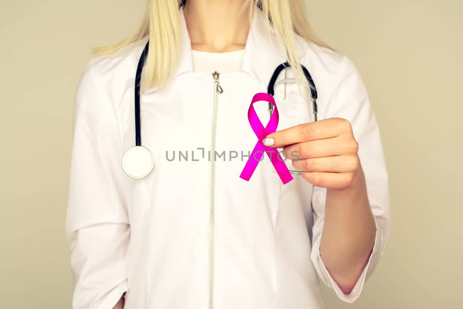 Female Doctor Holds Pink Ribbon, International Breast Cancer Day October 7 by zartarn