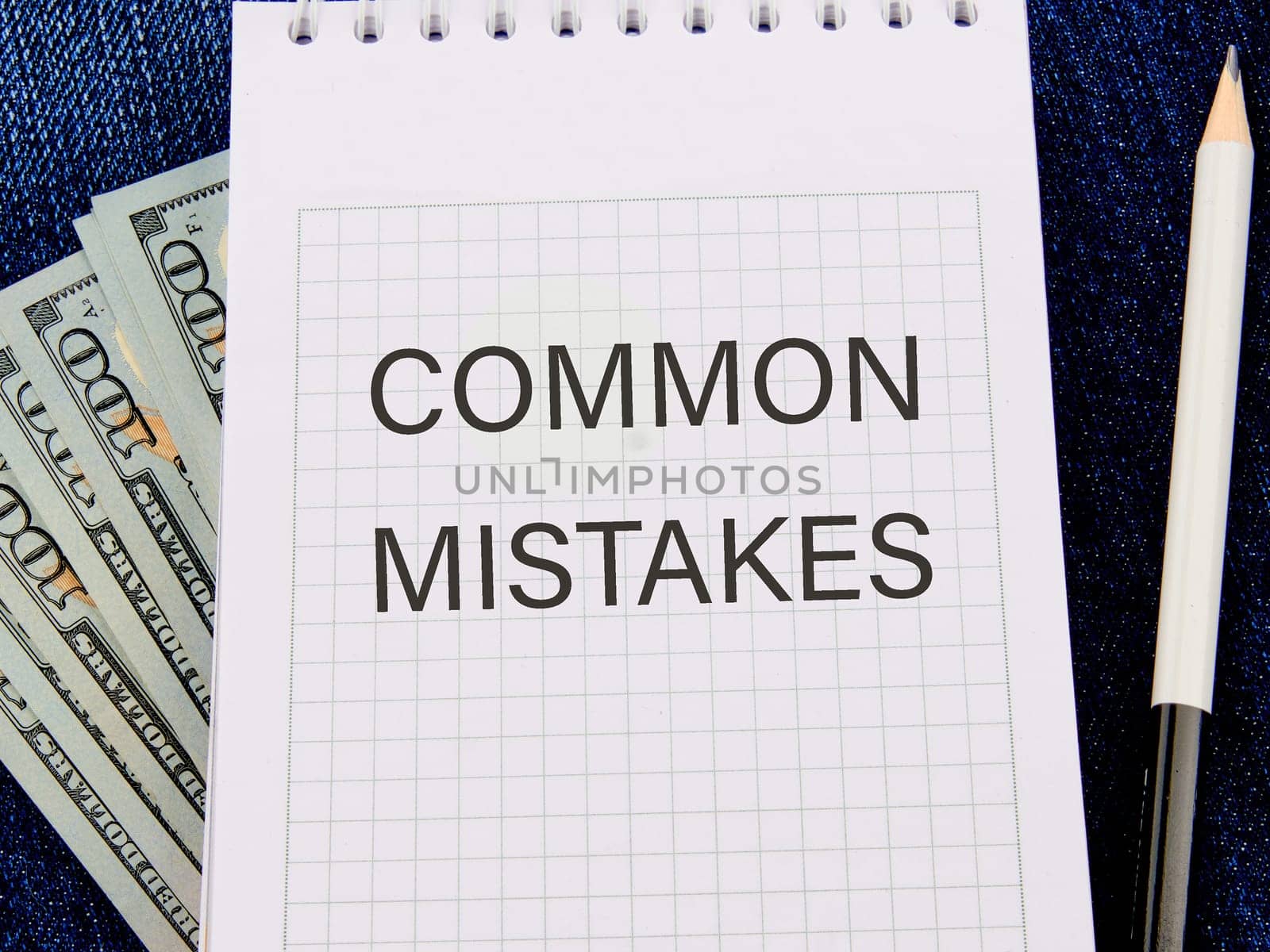 Common mistakes, text on a notepad against the background of money