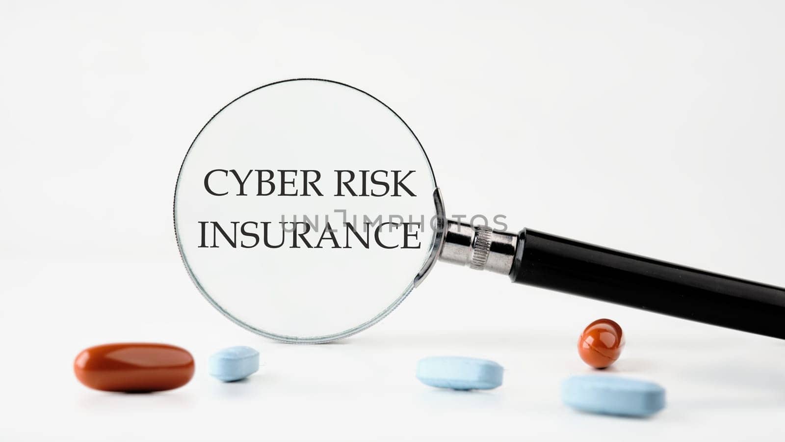 Cyber Risk Insurance text on a white background through a magnifying glass