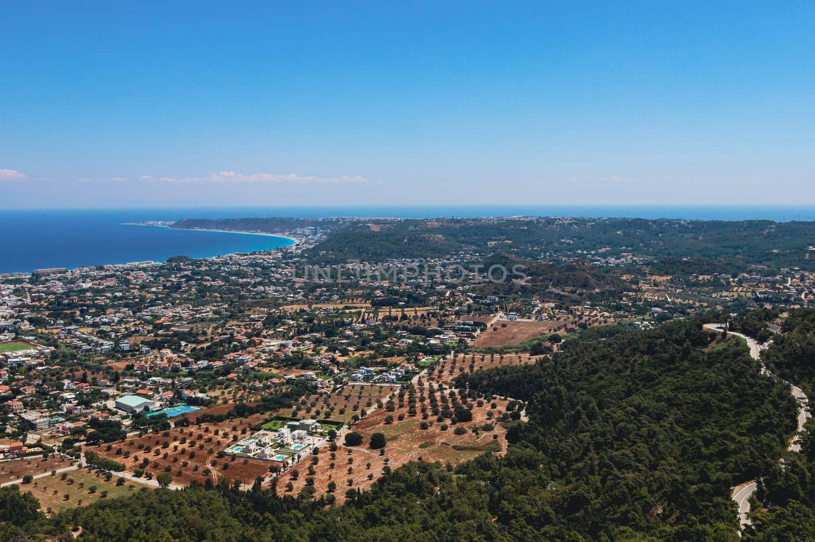 Beautiful panoramic view of the Aegean sea with the village and the blue sky from the Filerimos mountain in Greece on the island of Rhodes, close-up side view.