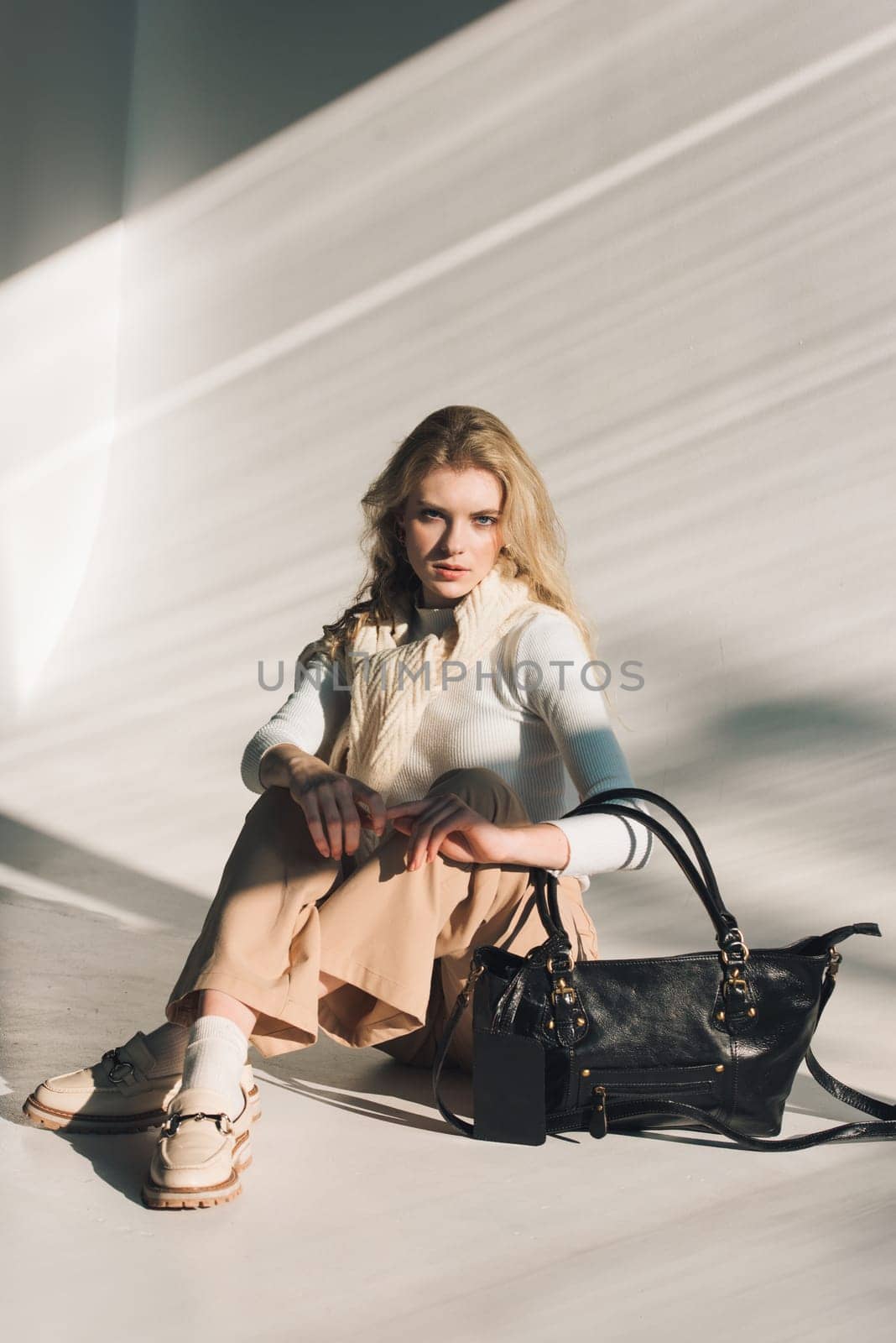 beautiful curly blond hair woman posing with a small shopper bag sitting on the floor by Ashtray25