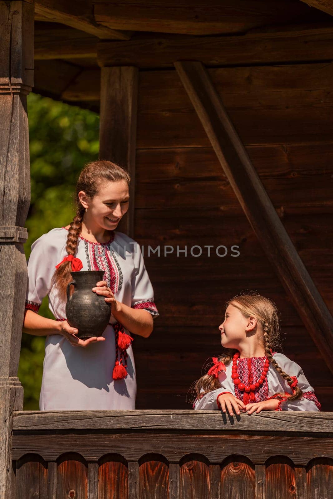 mother and daughter dressed in Ukrainian national costumes by zokov