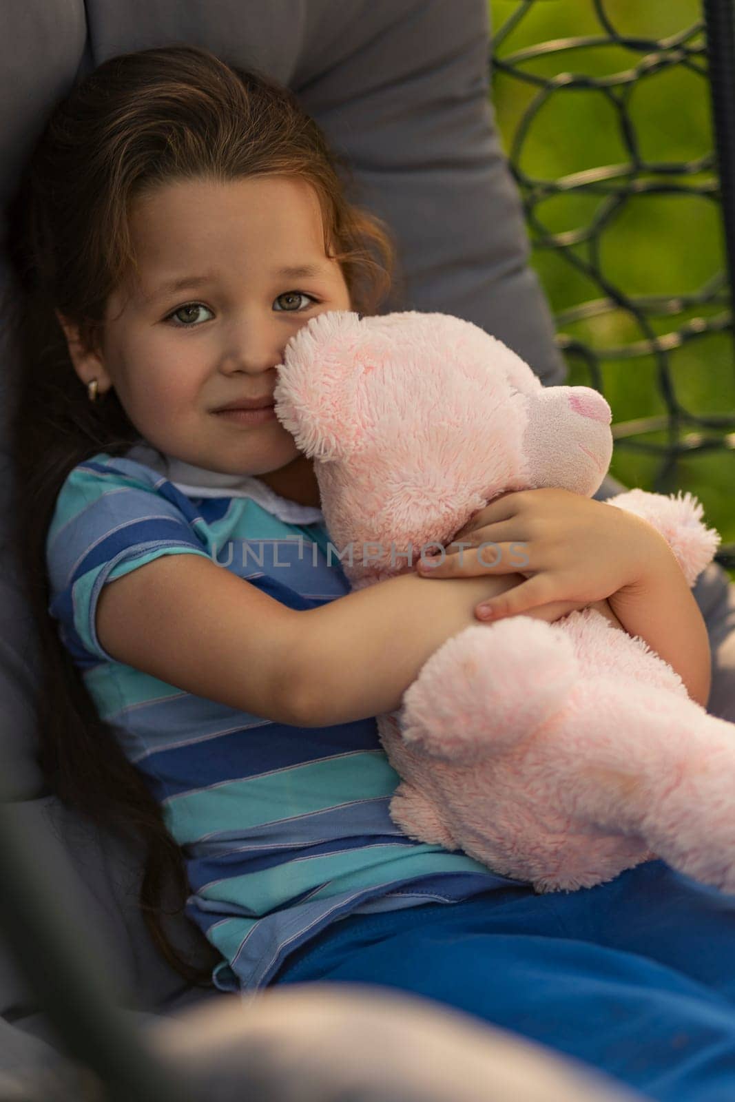 child hugging a teddy bear by zokov