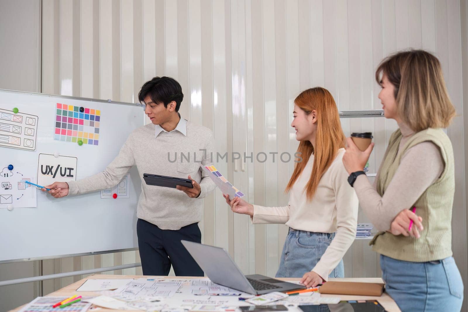 Creative team of designers in application design and ux ui usability planning. Modern business team teamwork..