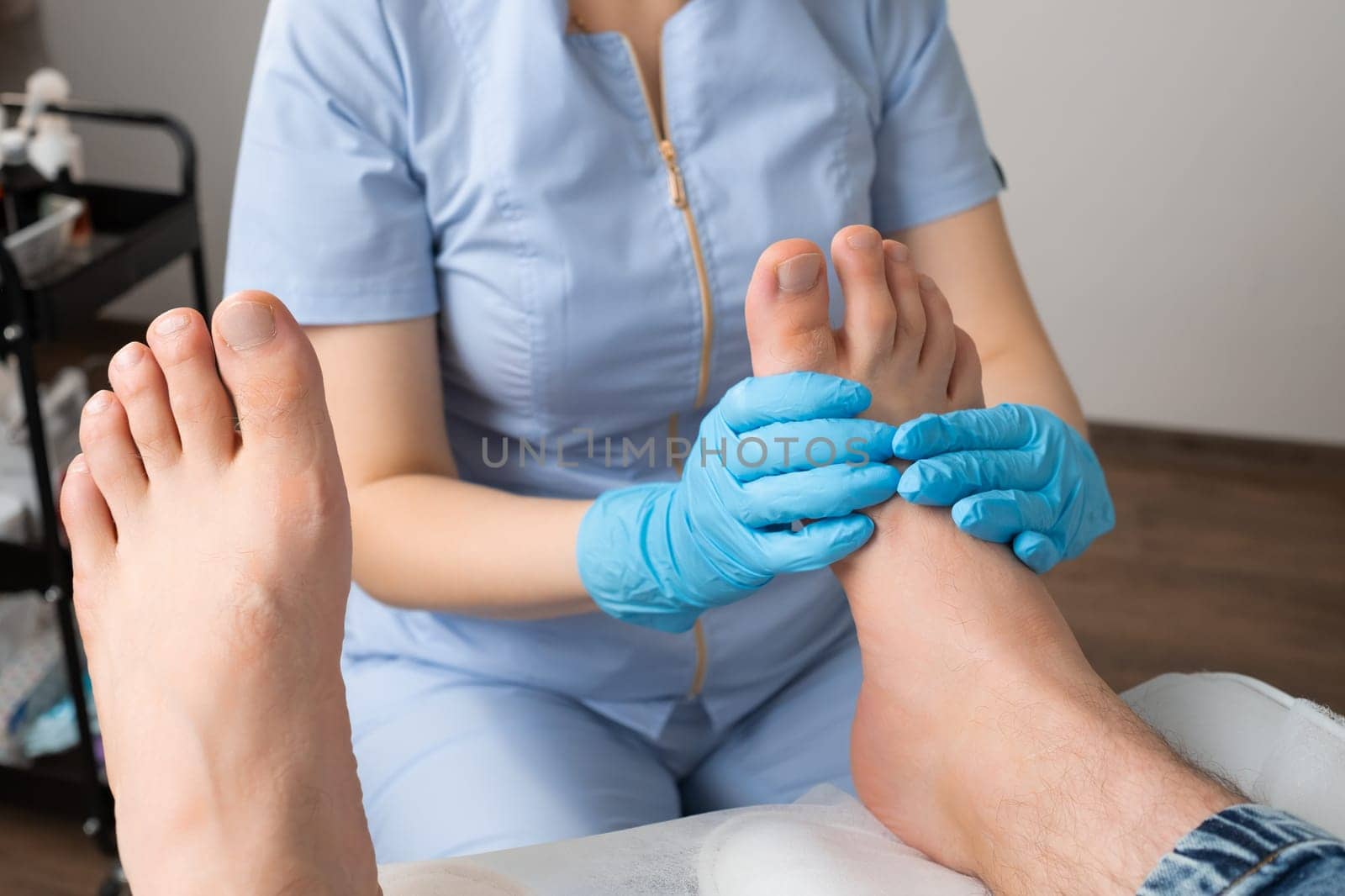 A man receiving a foot massage from a skilled masseur at the clinic