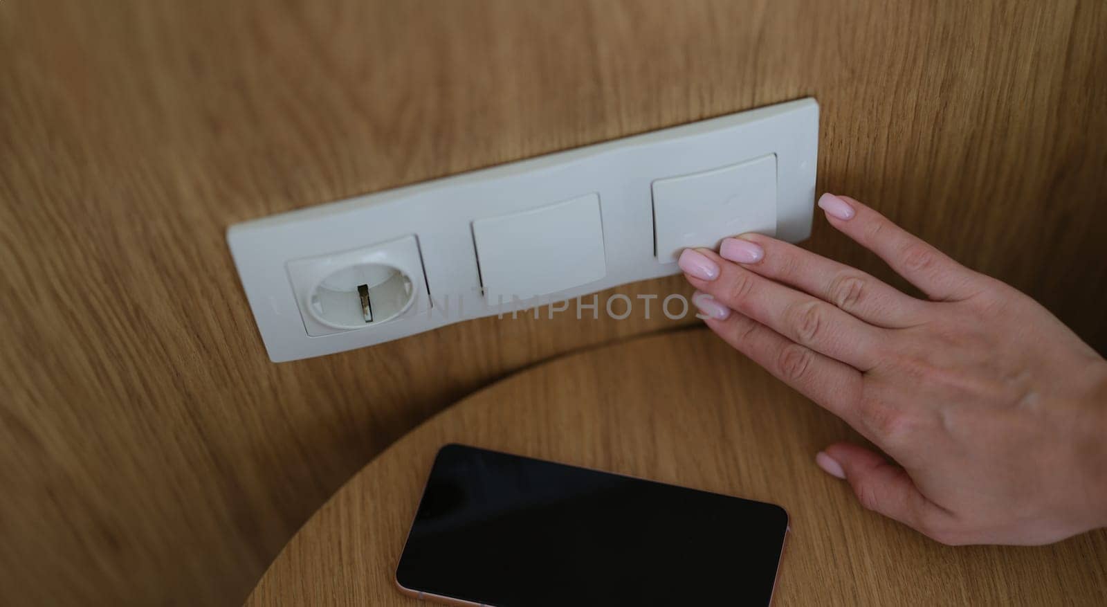 Woman hand presses on turn off lights closeup by kuprevich