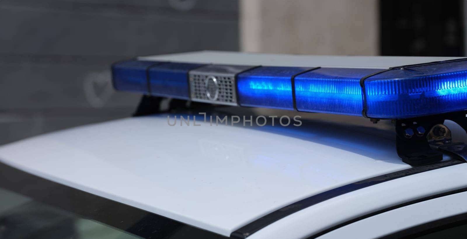 Police lights on car watching traffic on city road. Flashlight on car of ministry of emergency Situations and red blue flashing lights on cars of special forces concept