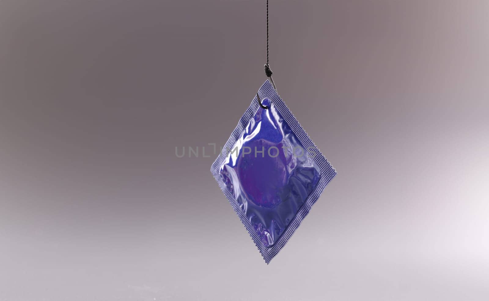 Condom package on a gray background. Safe sex and health by kuprevich