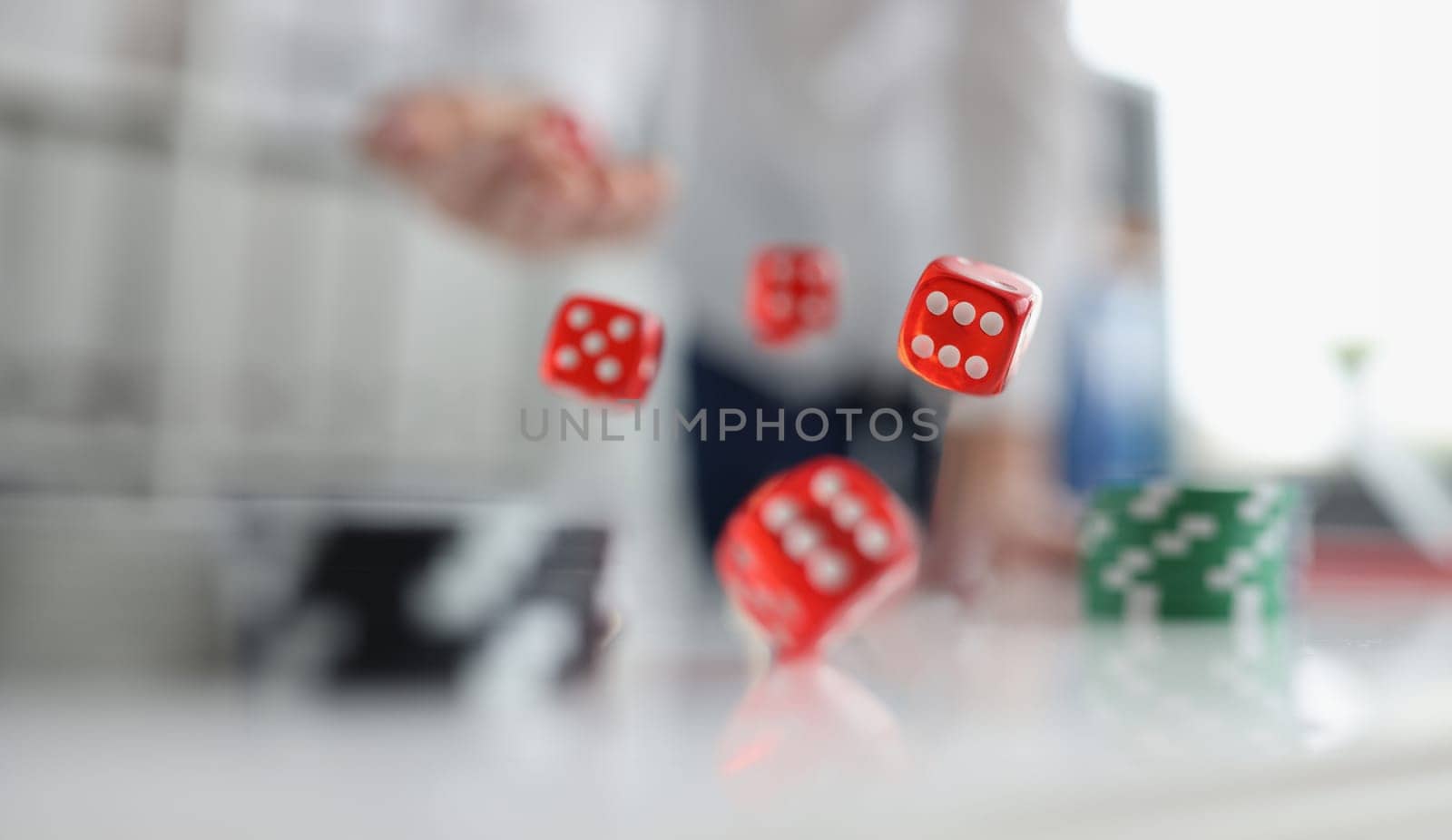 Closeup of person throwing dice. Addiction to gambling concept by kuprevich
