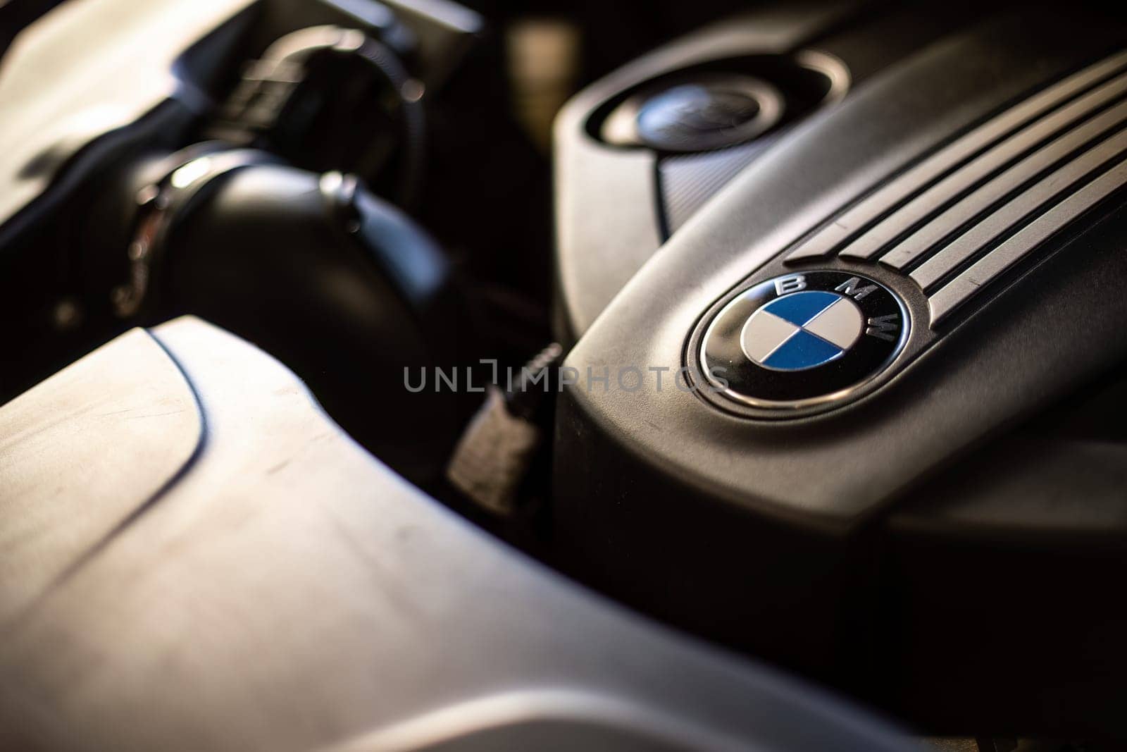 Milan, Italy 9 April 2024: Close-up of a BMW engine with the emblem clearly visible, showcasing automotive craftsmanship.