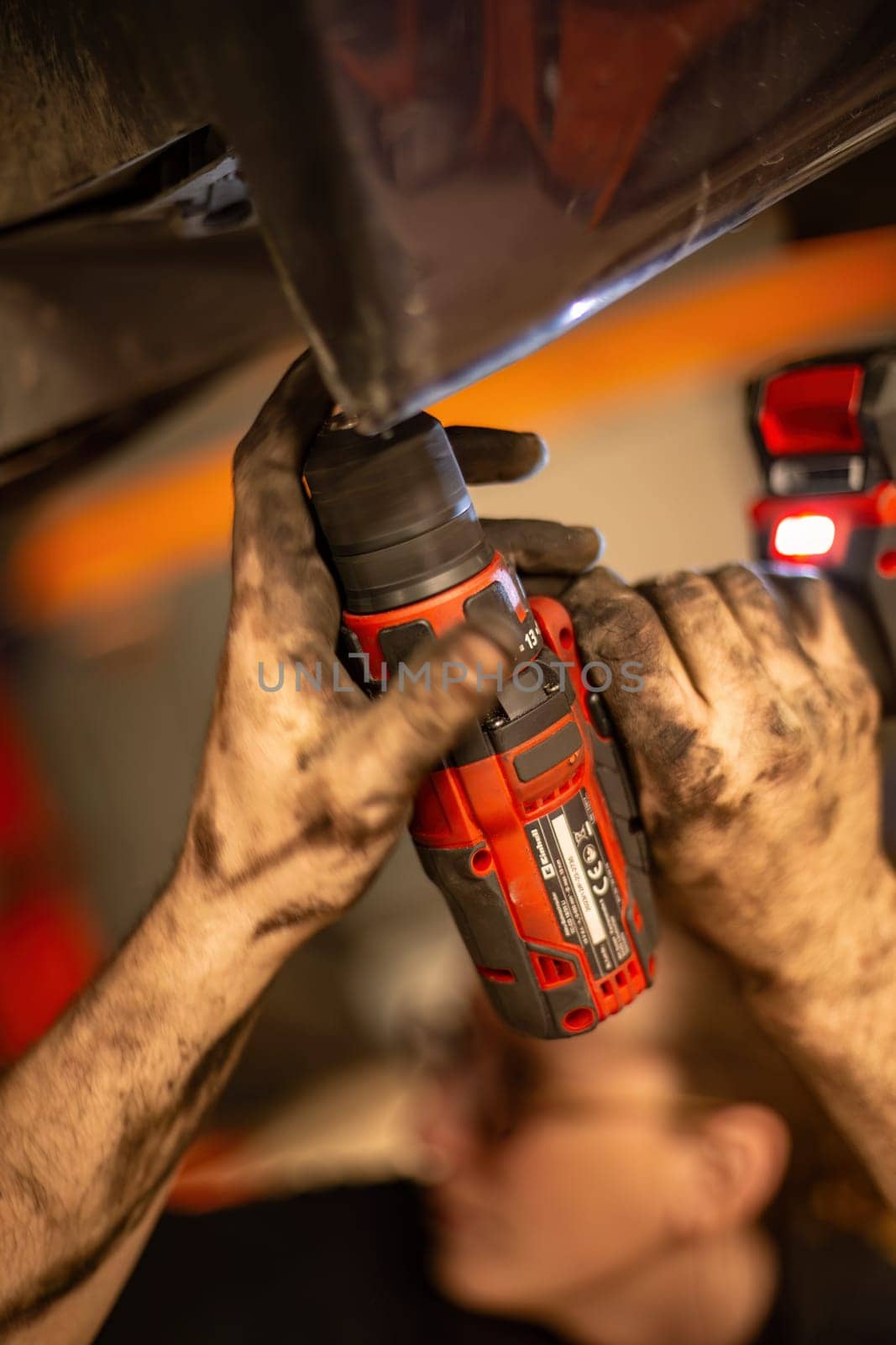 Milan, Italy 9 April 2024: A man skillfully wields a drill and a tool, immersed in his craft of invention and creation.