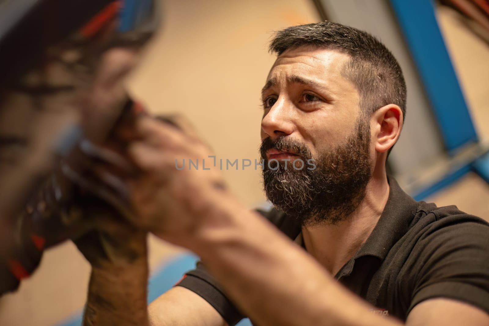 Milan, Italy 9 April 2024: Mechanic's hands delve into car engine under the hood, symbolizing repair and maintenance.