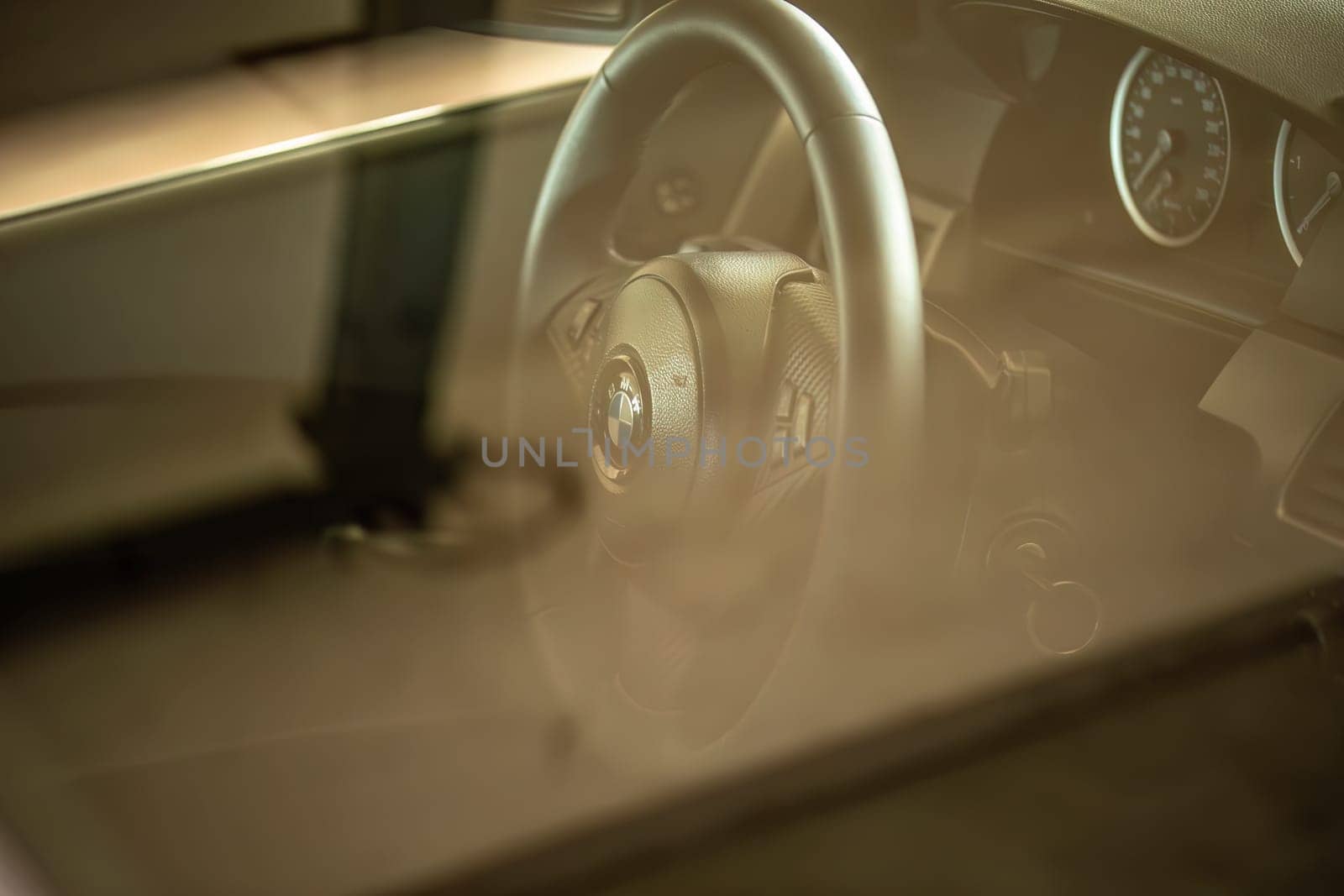 Milan, Italy 9 April 2024: Detailed view of a BMW car interior showcasing the steering wheel with the visible emblem.