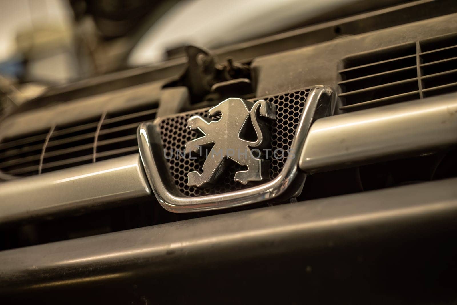 Milan, Italy 9 April 2024: Close-up of the iconic Peugeot emblem on a car.