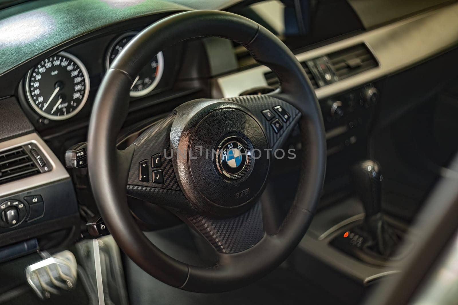 Milan, Italy 9 April 2024: Detailed view of a BMW car interior showcasing the steering wheel with the visible emblem.