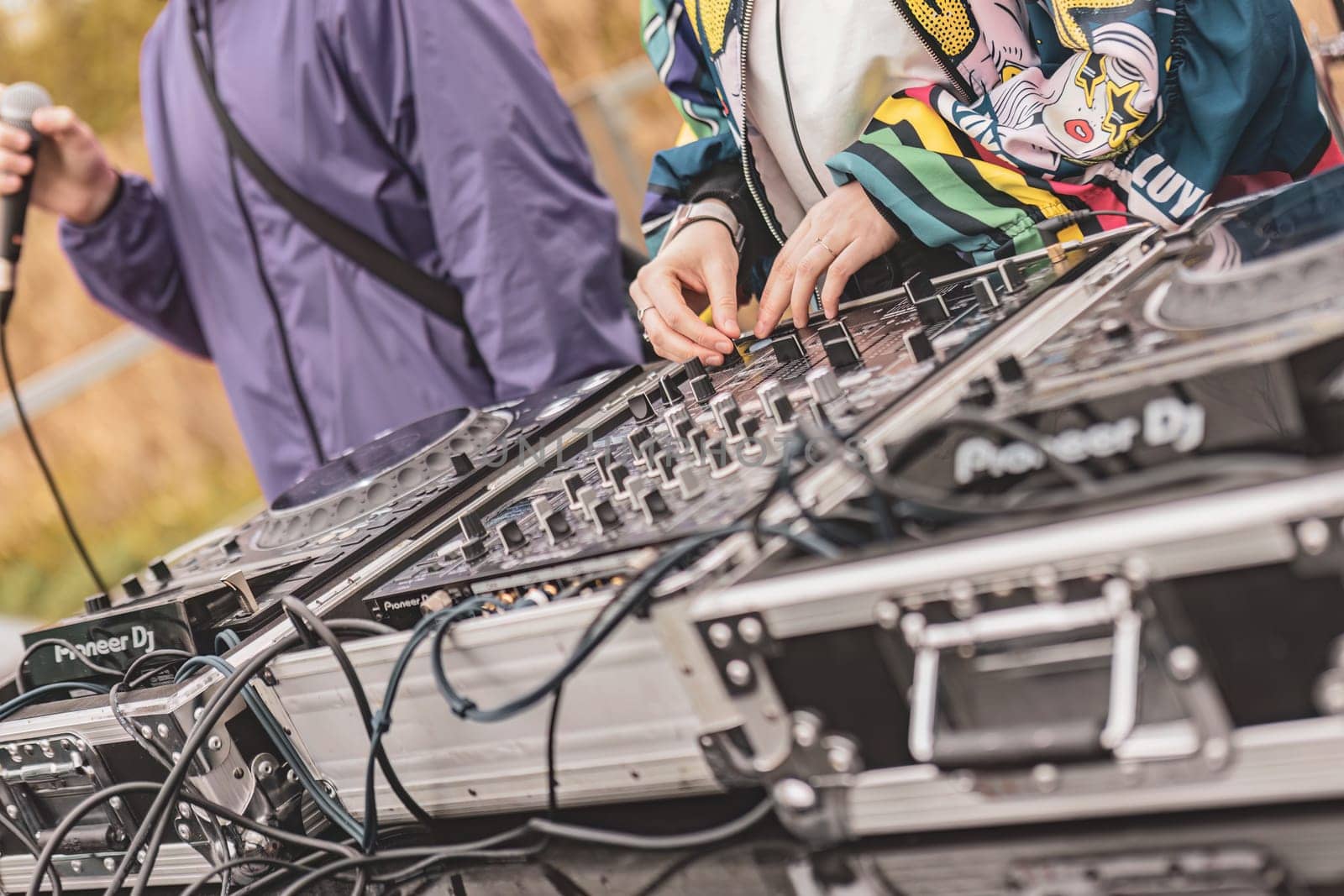 Milan, Italy 1 April 2024: Close-up of DJs' hands manipulating a console, energizing the rave party with their thrilling music set.