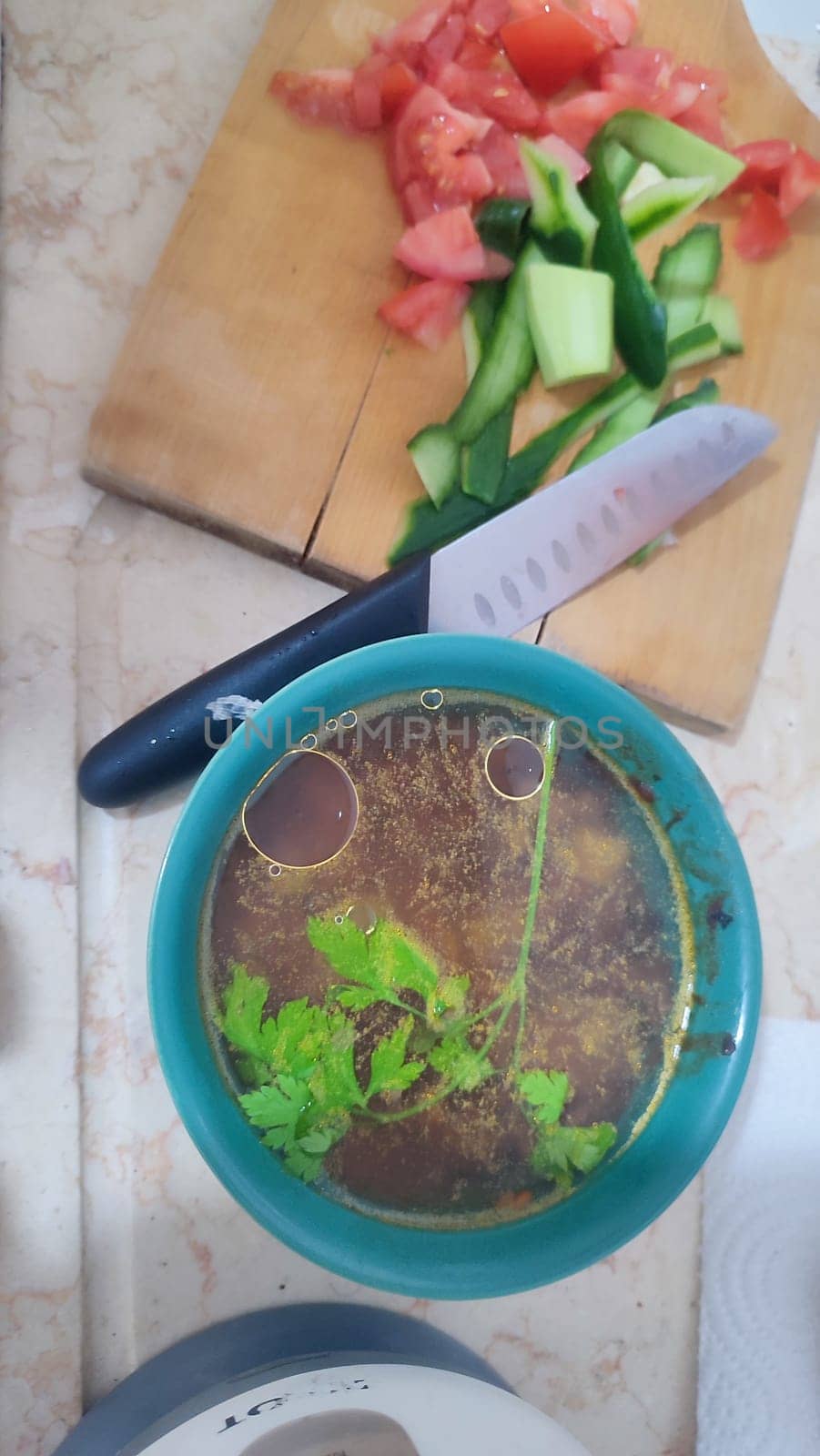 soup in a plate, tomatoes and cucumbers on a board, food lunch cooking. High quality photo