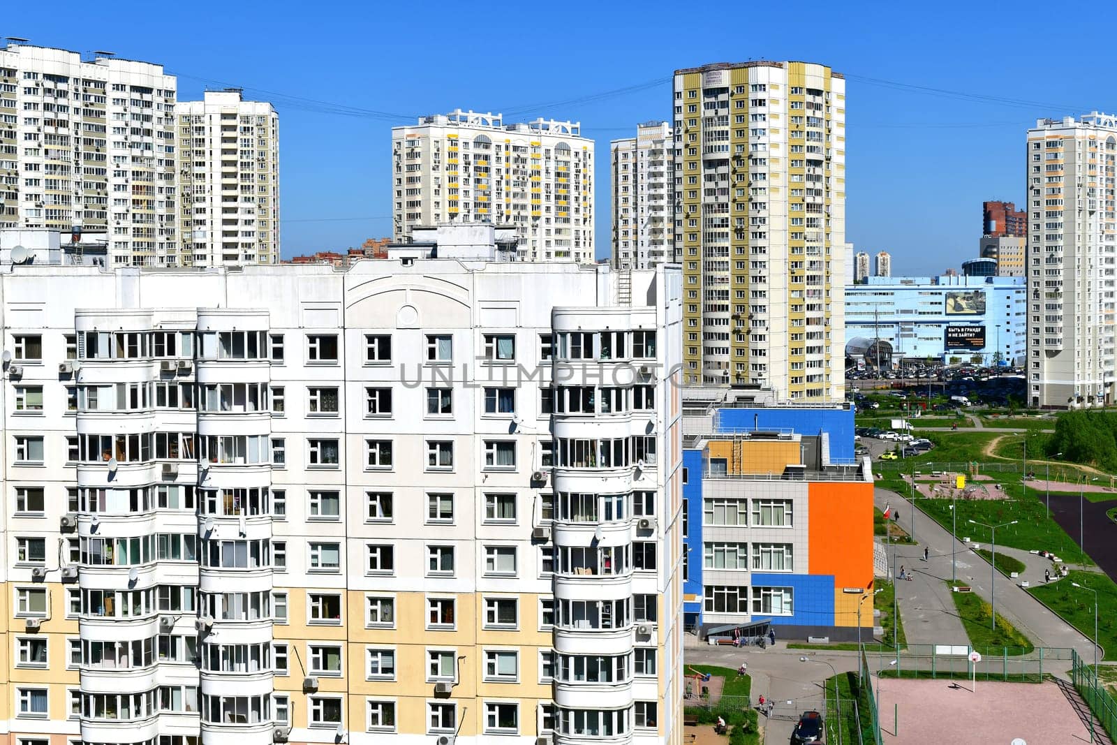 Khimki, Russia - May 10. 2018. Cityscape with residential buildings, cars and road by olgavolodina