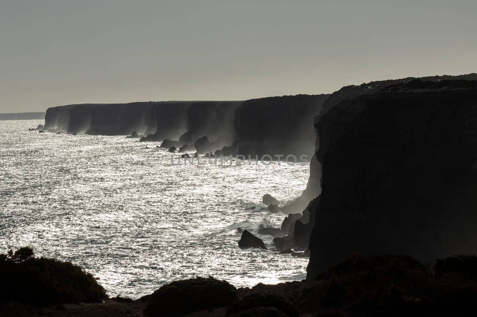 Moody and beautiful cinematic photo of the famous Bunda cliffs in the Nullarbor, silhouetted at sunset to create a monochromatic look, South Australia.