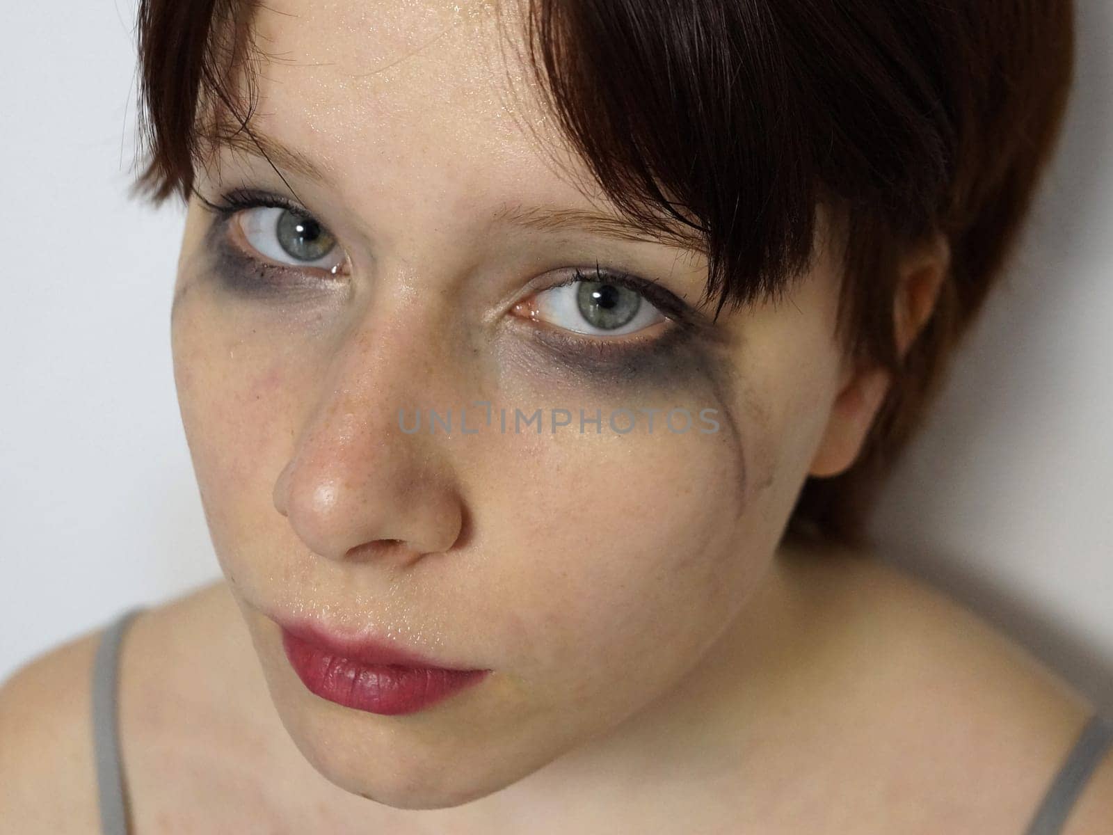 close-up portrait of a tear-stained teenage girl with mascara smeared eyes by Annado