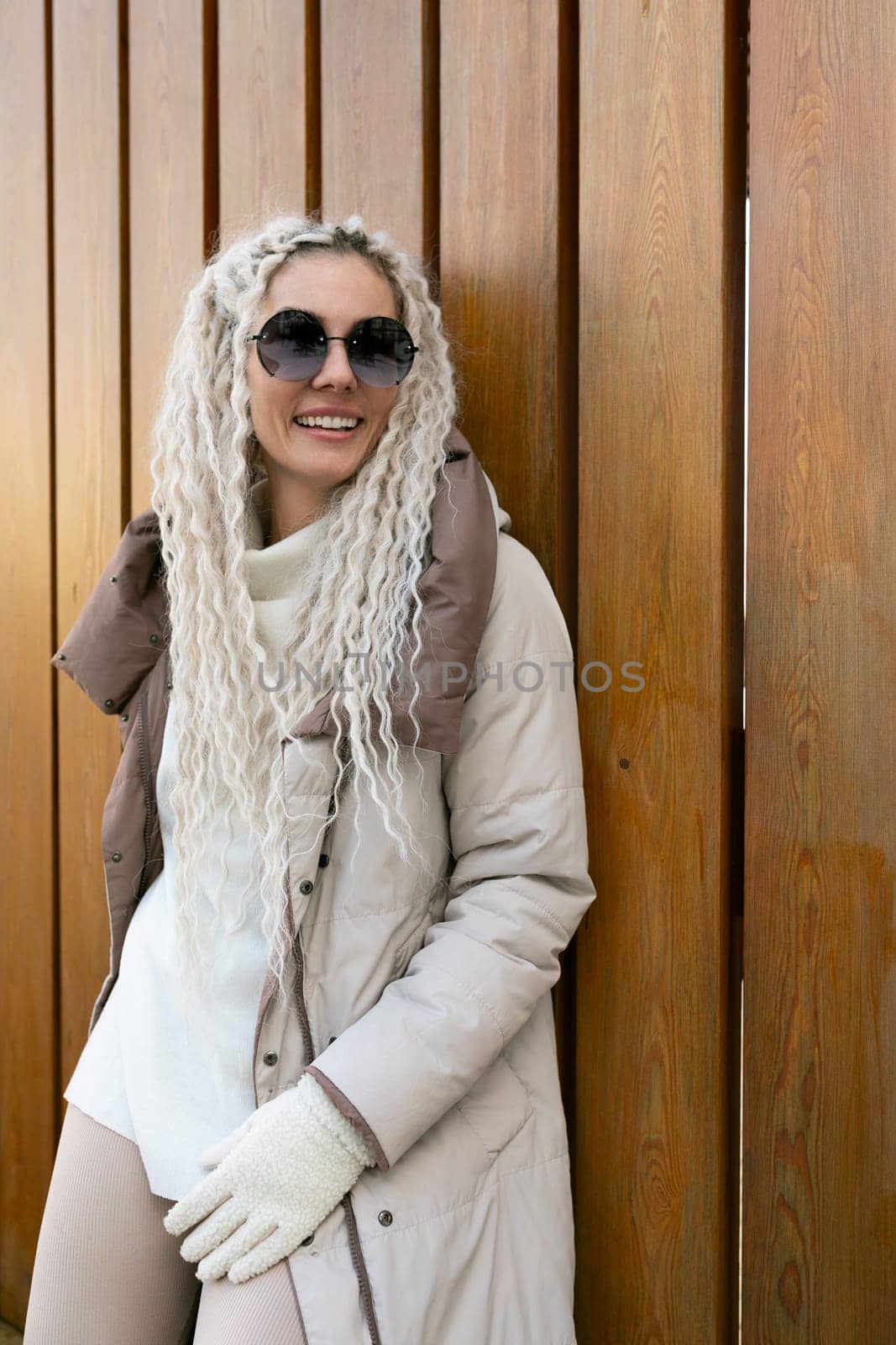 Woman With Long White Hair Wearing Coat and Gloves by TRMK