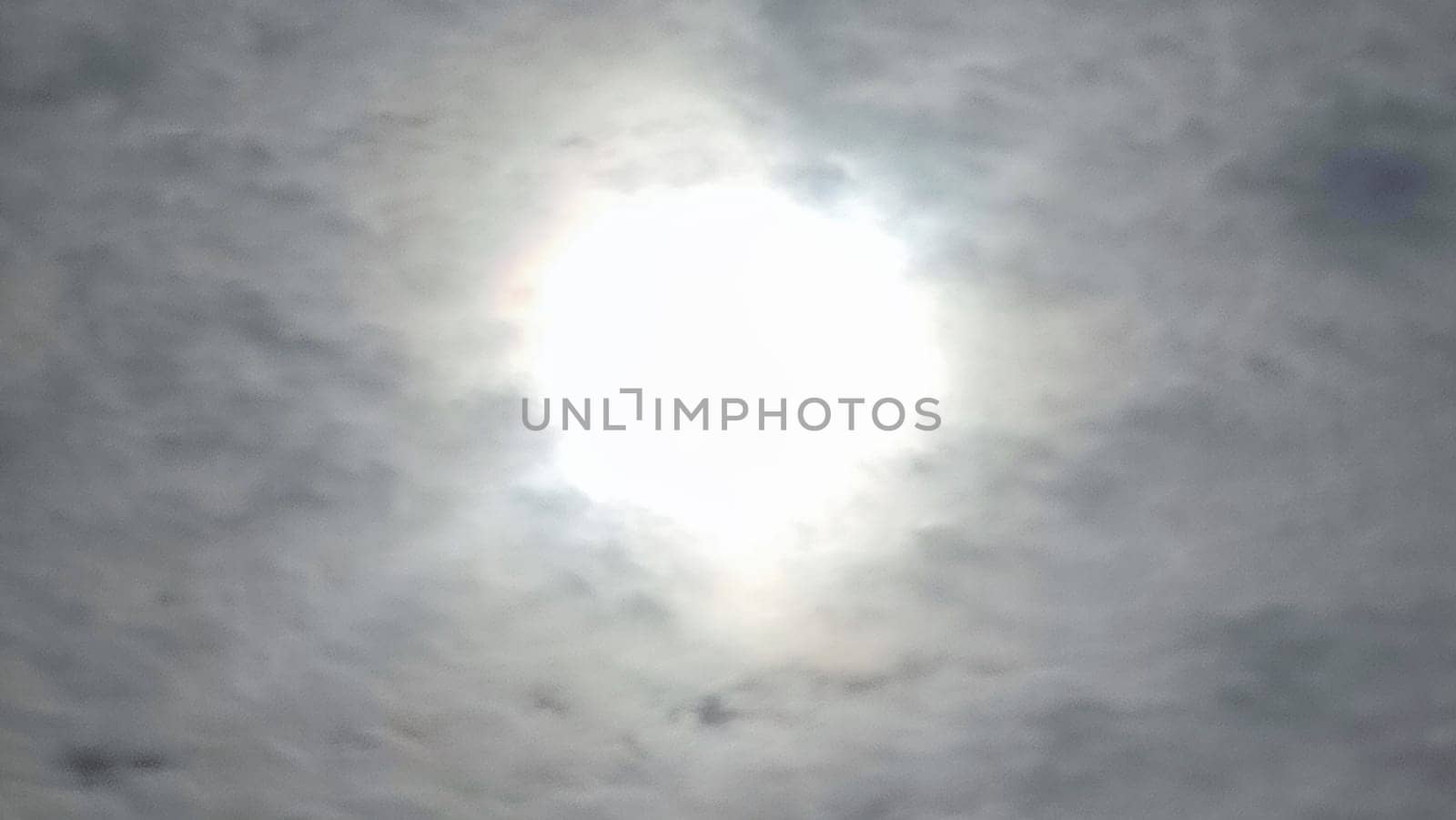 Blue gray light sky nature white clouds whether background, sun face . High quality photo