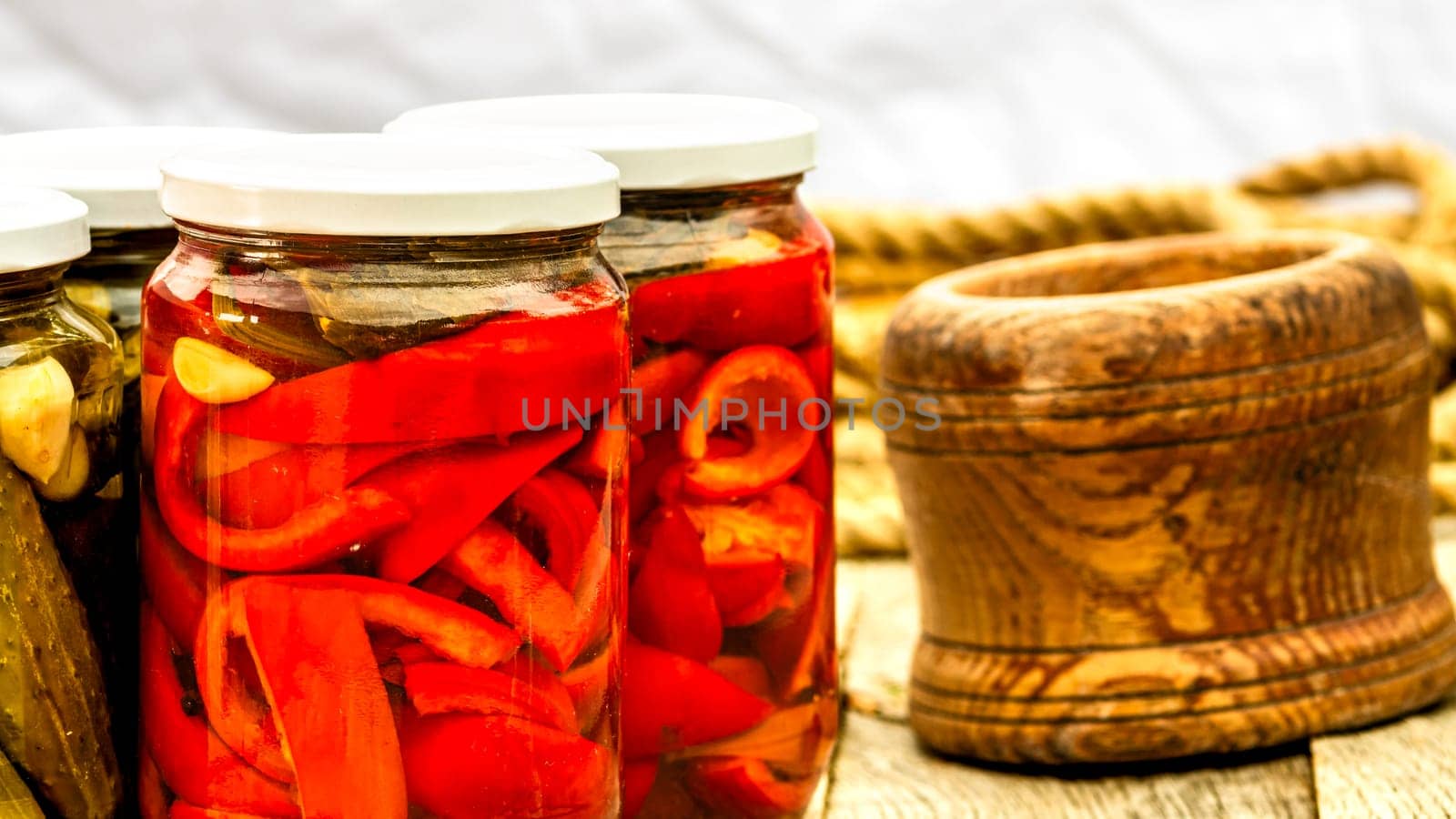 Glass jars with pickled red bell peppers. Preserved food concept, canned vegetables