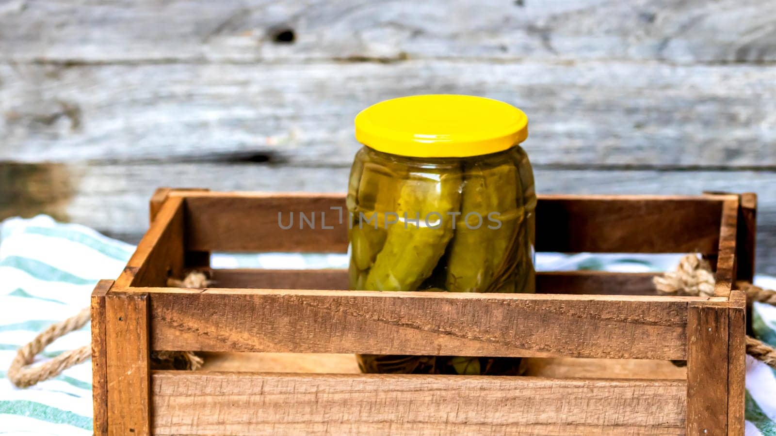 Glass jar with pickles isolated. Preserved food concept, canned vegetables isolated in a rustic composition. by vladispas