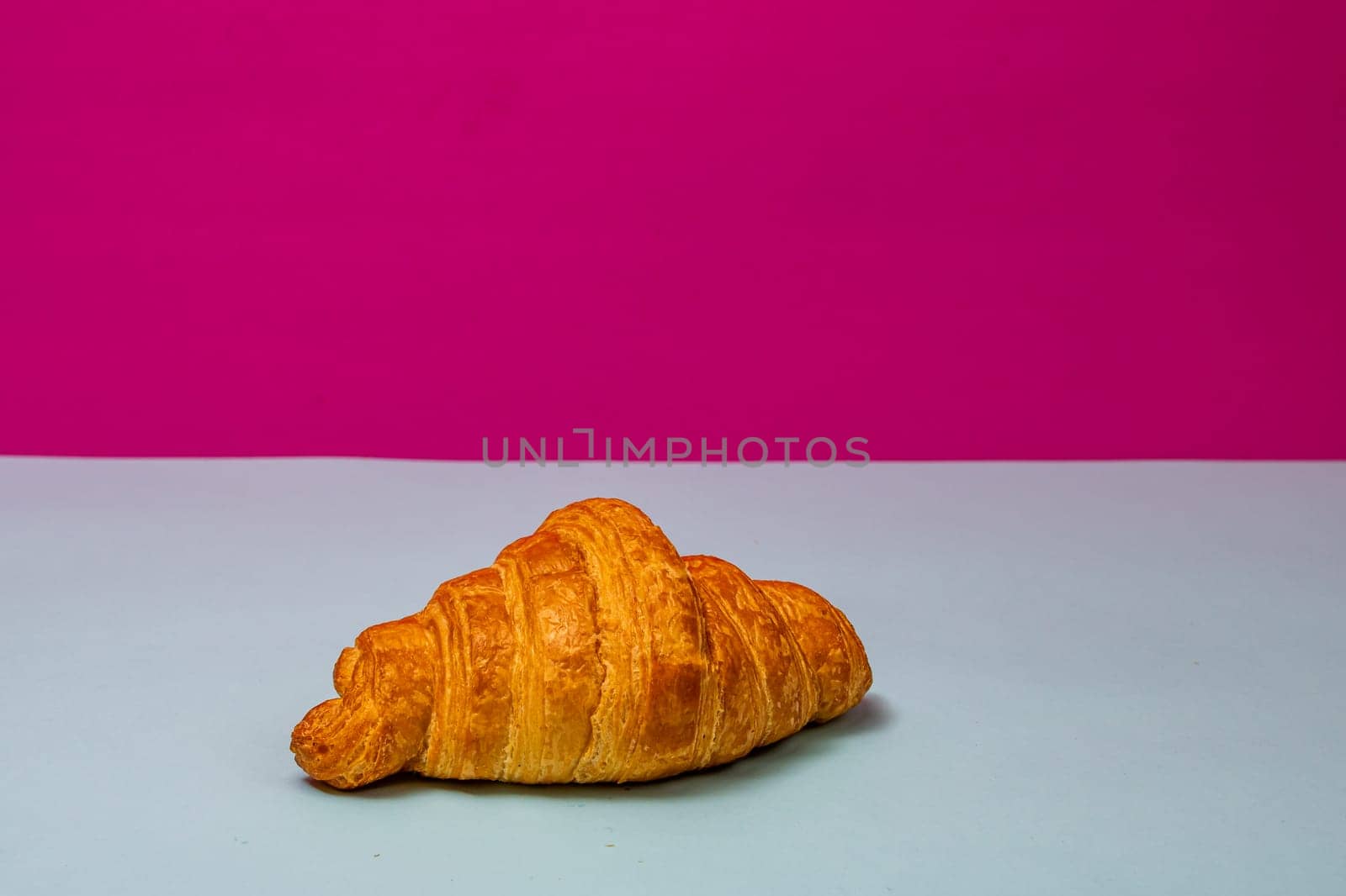 Detail of fresh croissant isolated, french breakfast concept. by vladispas
