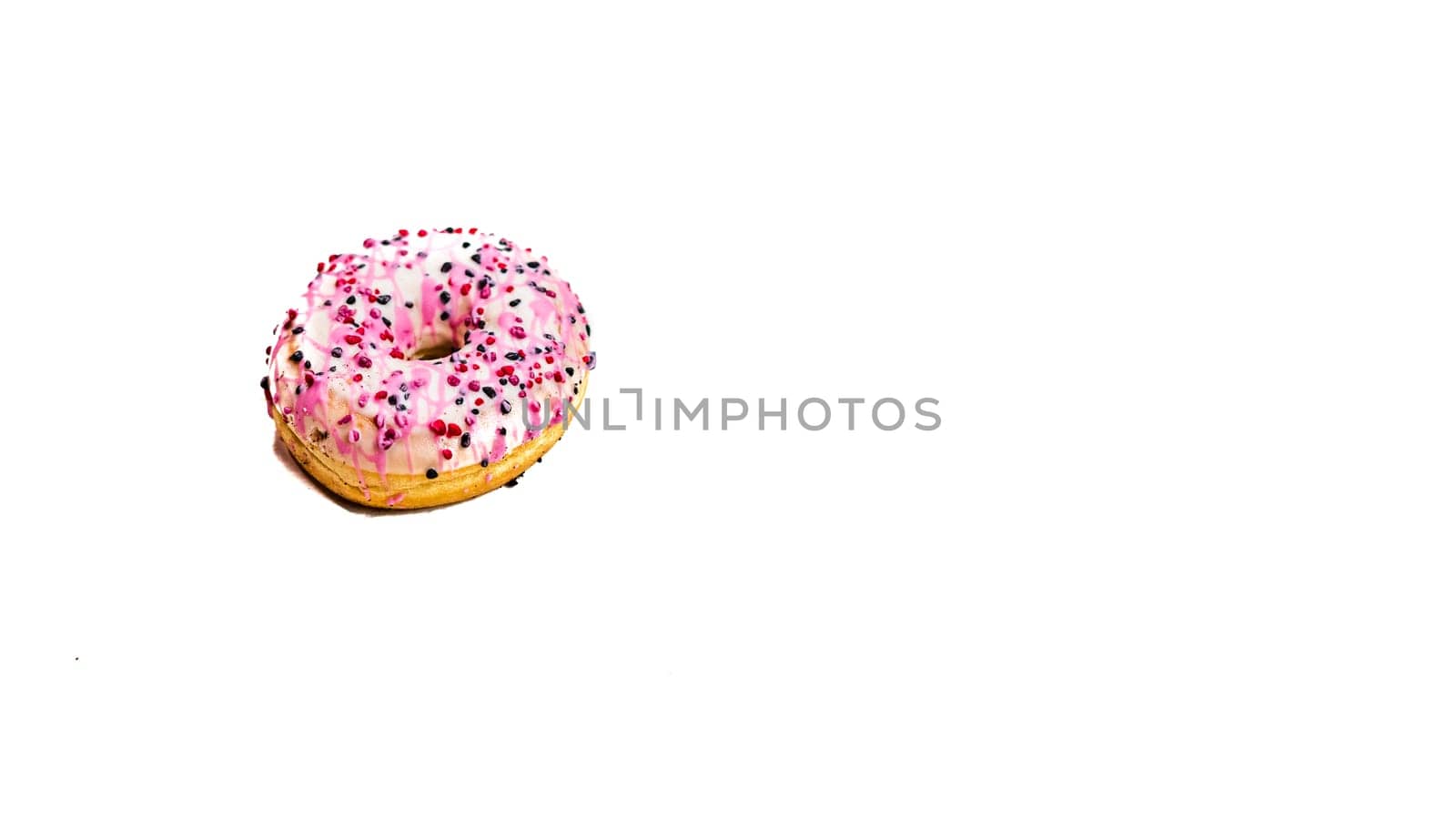 Colorful donut isolated on white. Sweet icing sugar food with glazed sprinkles, doughnut with frosting. Top view with copy space