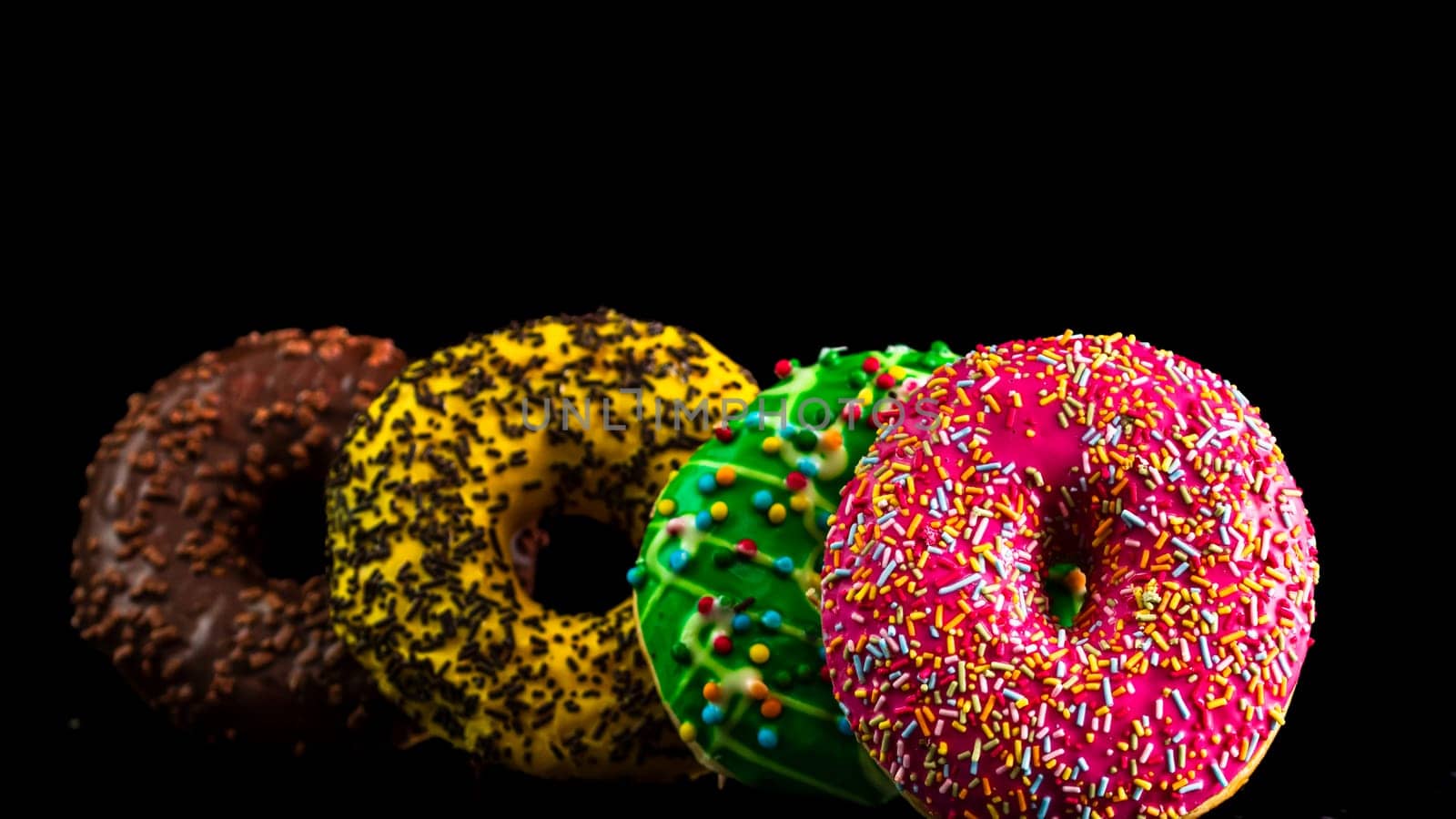  Glazed donuts with sprinkles isolated. Close up of colorful donuts. by vladispas
