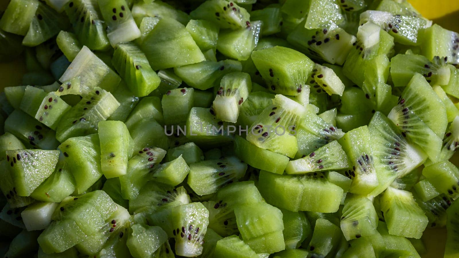 Ripe kiwi fruit. Detail of chopped exotic kiwi fruits used for desserts by vladispas