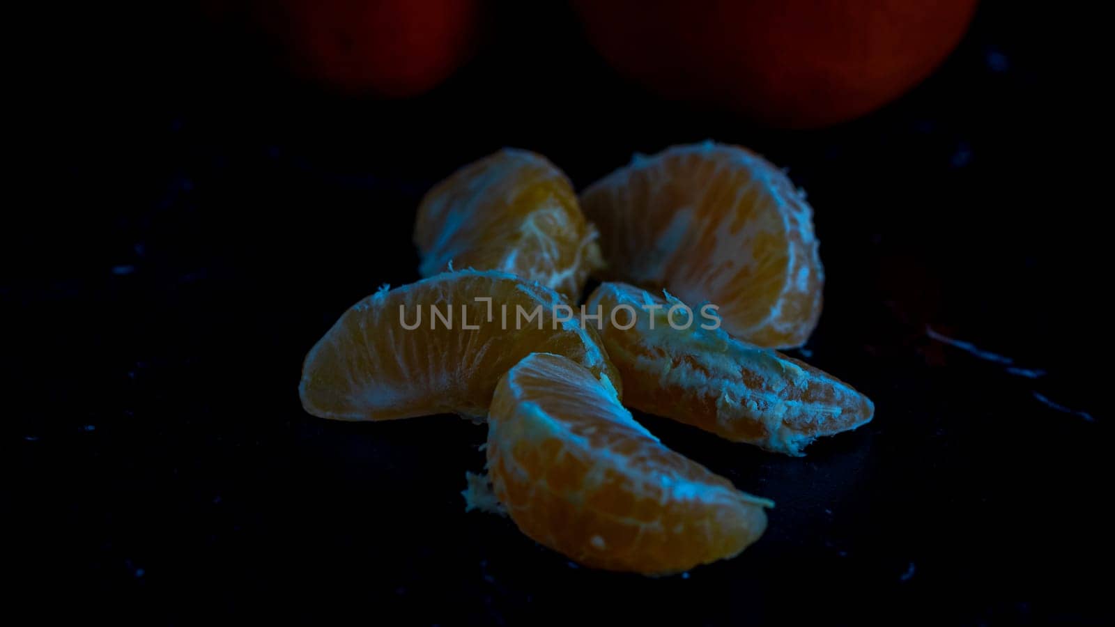 Detail of orange fruit on black background