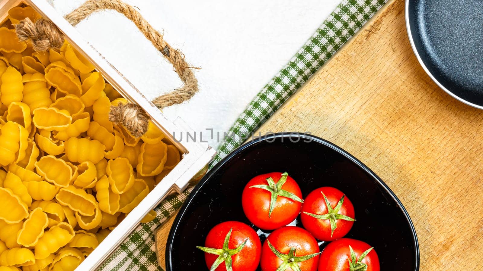 Beautiful tasty Italian pasta, tomatoes, onions and garlic for cooking pasta by vladispas