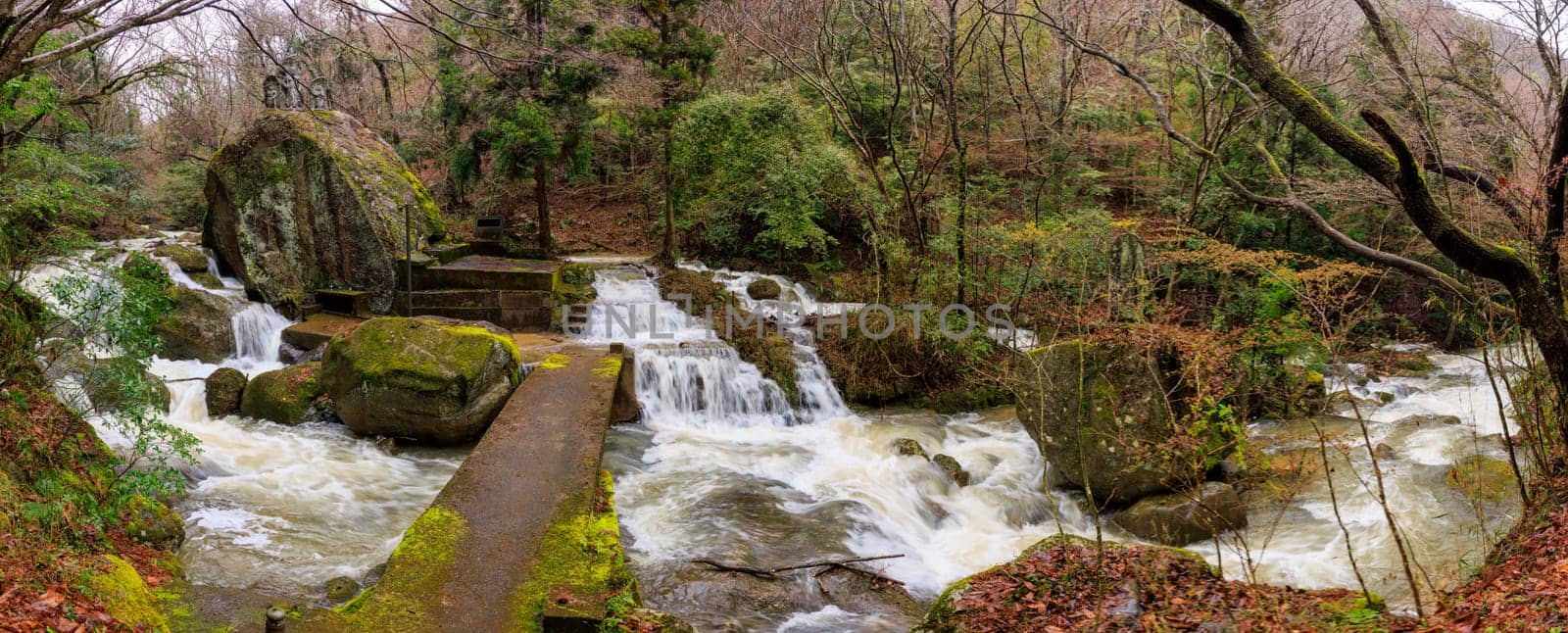 Flowing water floods stairs by bridge and Japanese in shrine after rain. High quality photo