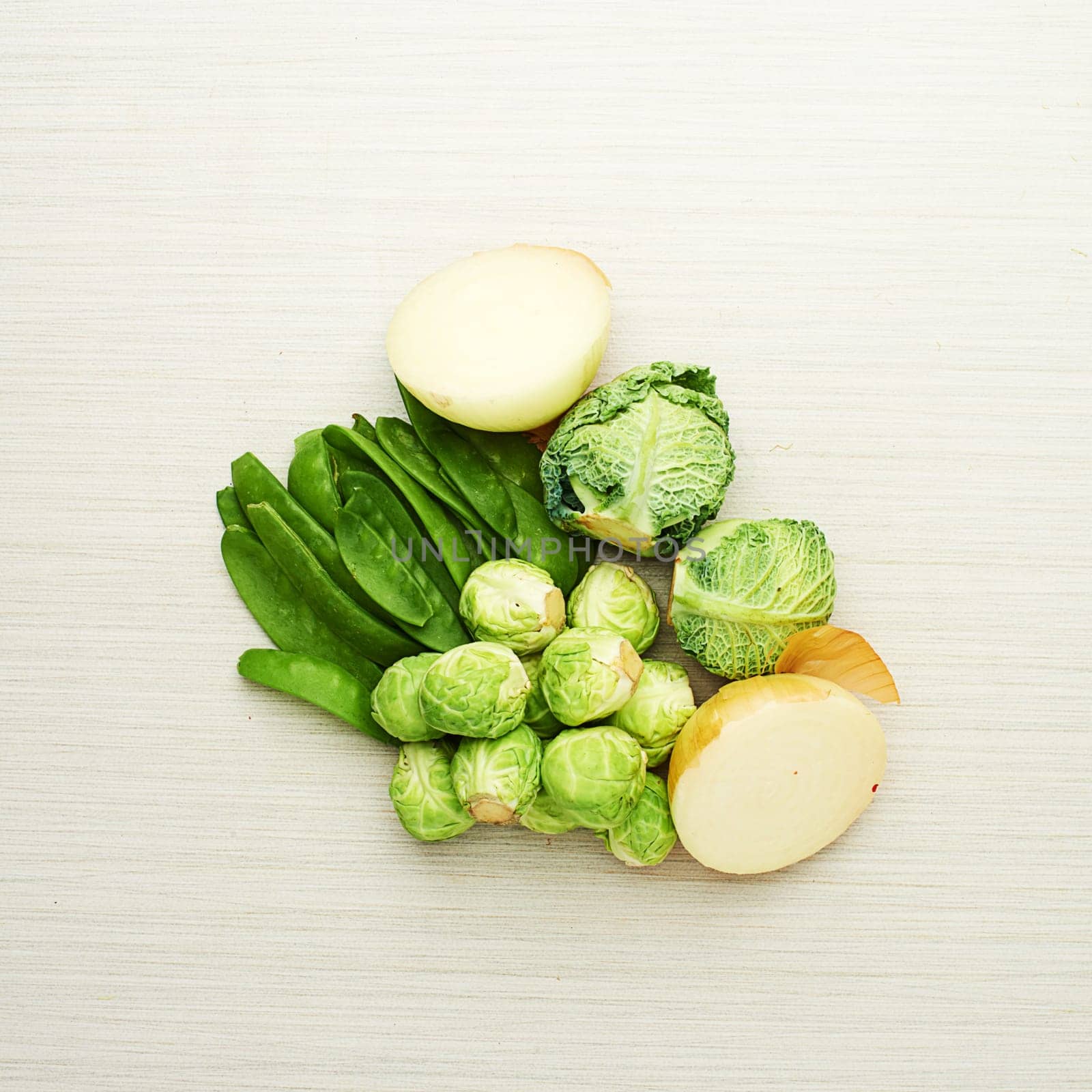 Healthy, vegetables and nutrition from ingredients on table for soup, recipe and meal prep in kitchen. Onion, cabbage and brussels with peas for dinner, food and green diet for wellness in home.