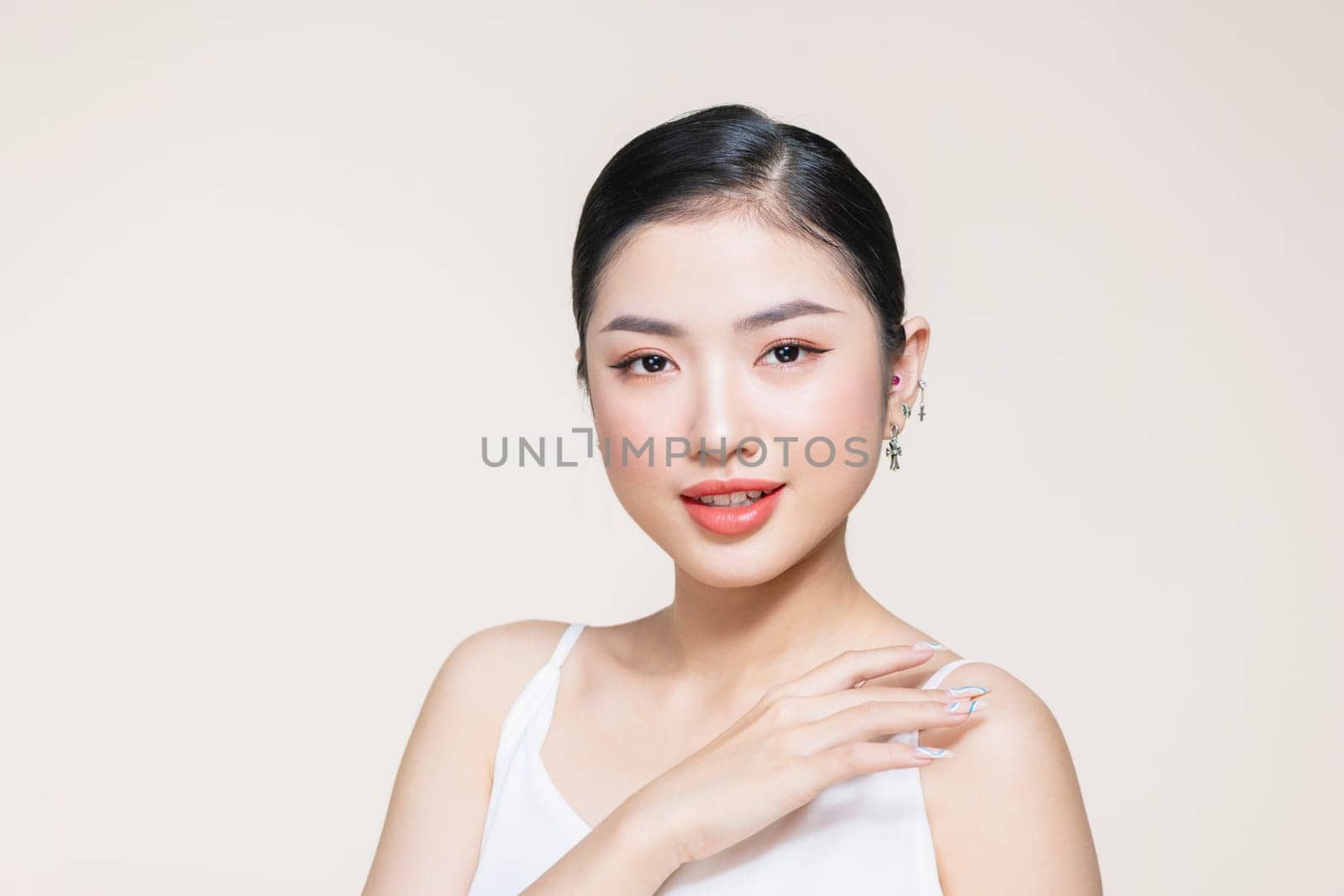 Skin protection, Young asian woman's hand is touching her smooth skin on the shoulder