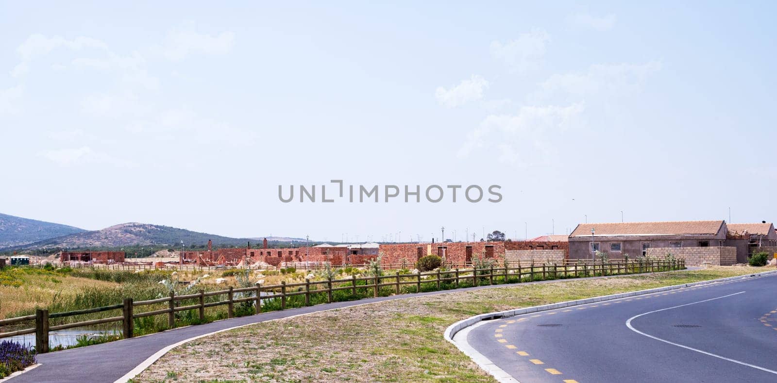 Residential area, under construction and secure path for walking, cycling or pedestrians. Architecture, development and building for commercial real estate, family homes or community housing by YuriArcurs