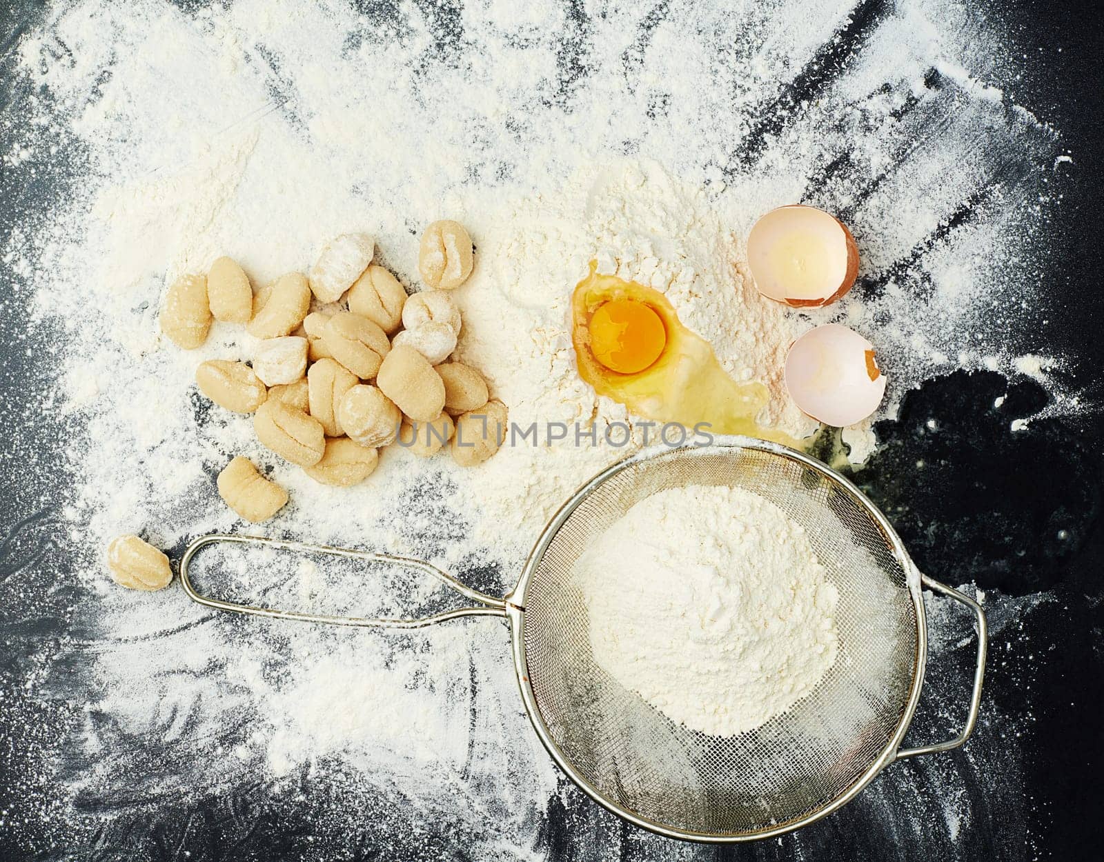 Eggs, flour and pasta for cooking in kitchen with Italian cuisine, dough recipe and dinner ingredients. Gnocchi, table top and carbs on dark background for healthy eating, yellow color and lunch food by YuriArcurs