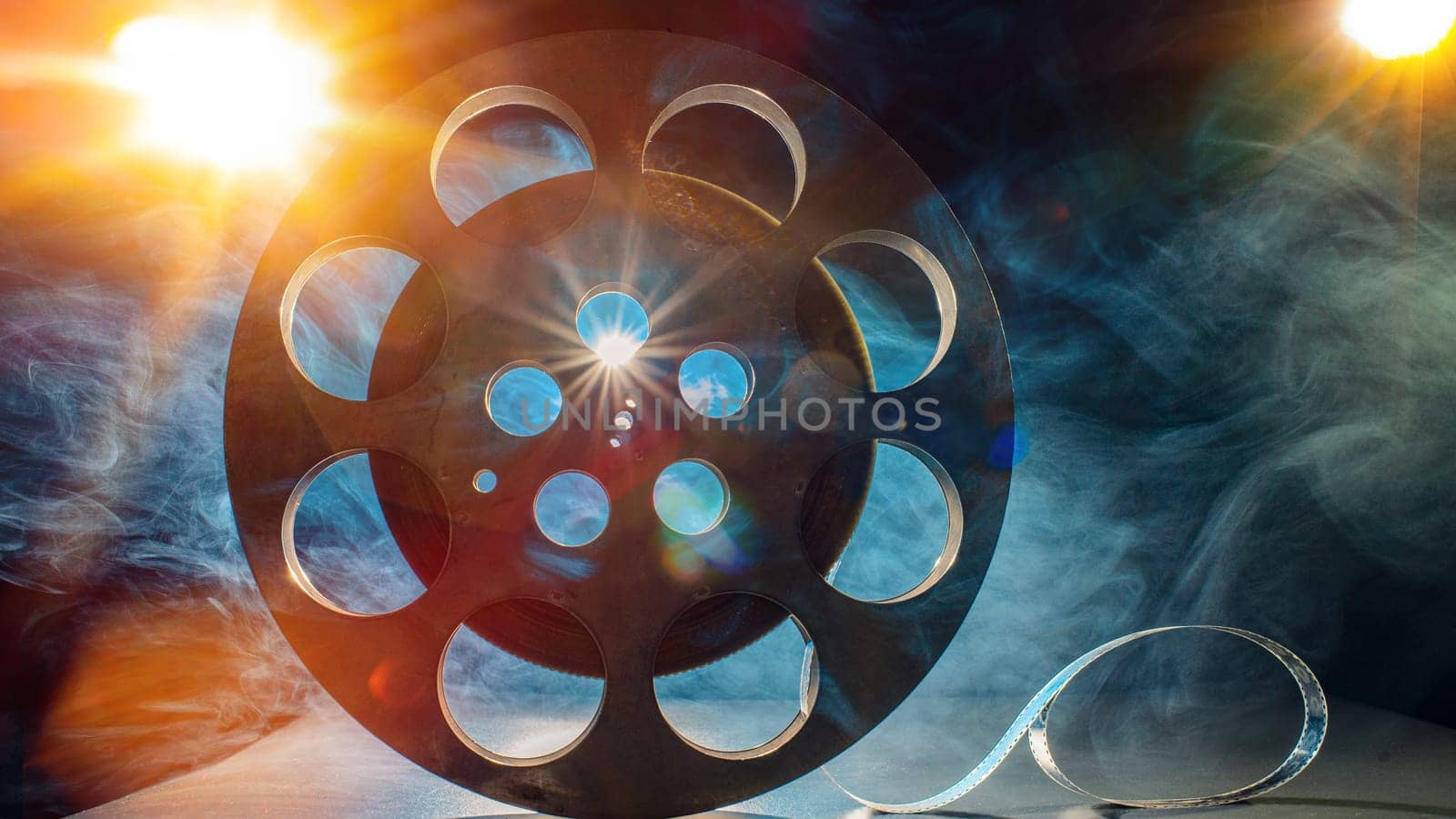 Metal reel of film on a dark background by zartarn