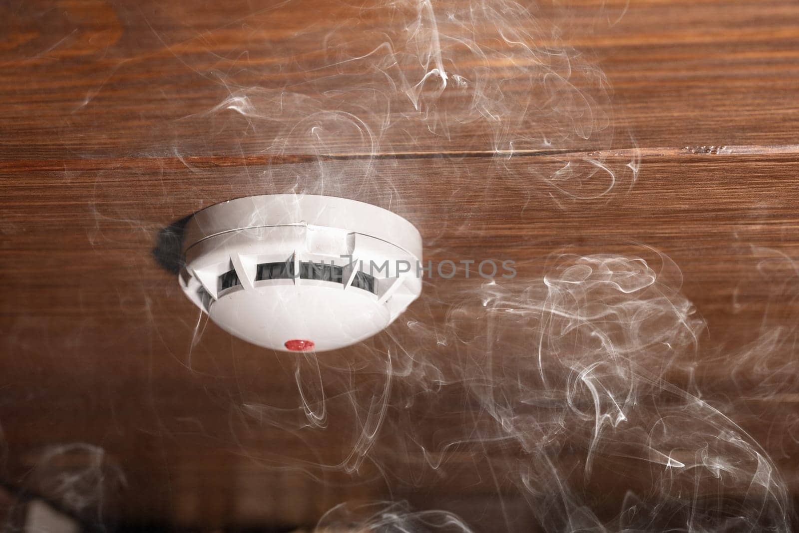 Smoke detector and fire alarm in action background with copy space