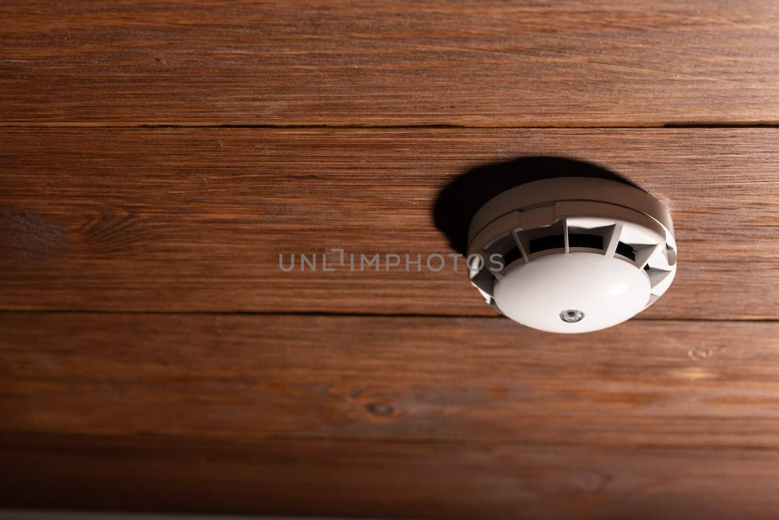 Alarm fire detected Smoke detector on wooden ceiling by zartarn