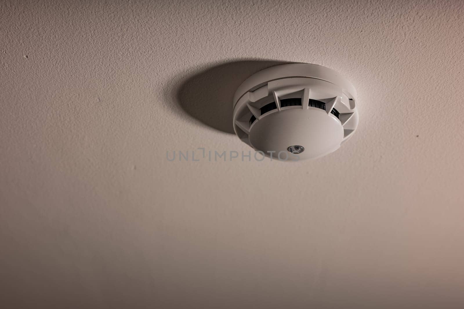 Alarm fire detected Smoke detector on white ceiling by zartarn