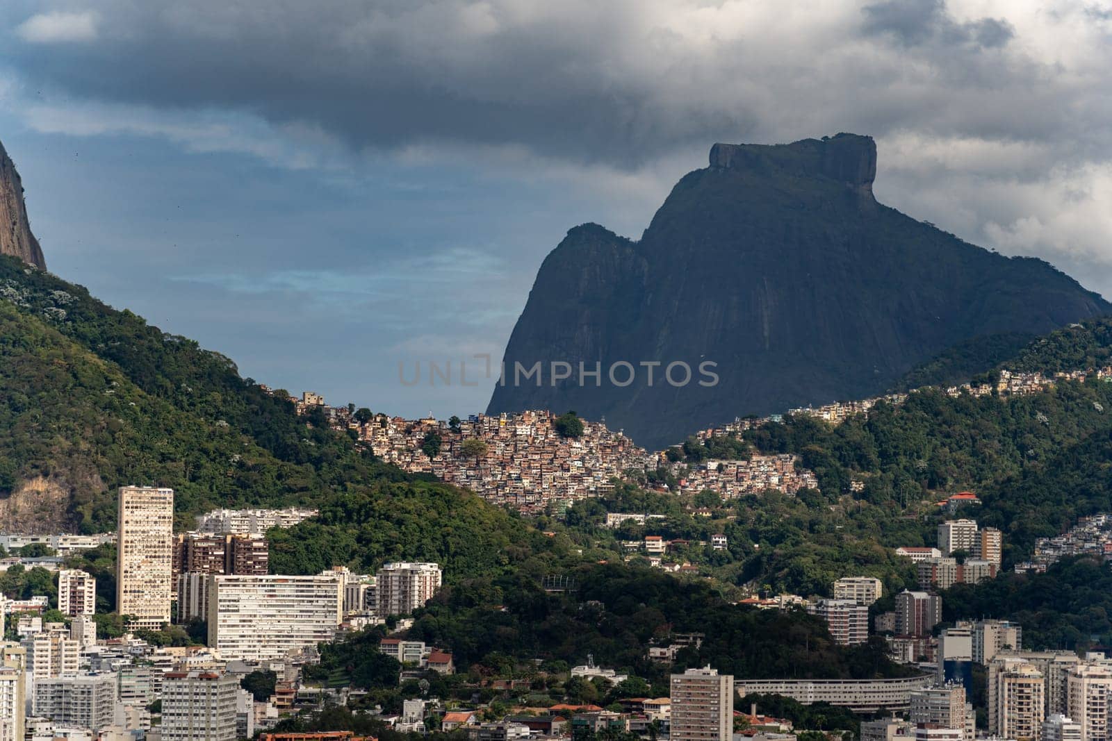 Iconic Rocinha favela lies at Two Brothers hill and Pedra da Gavea base in Rio de Janeiro.