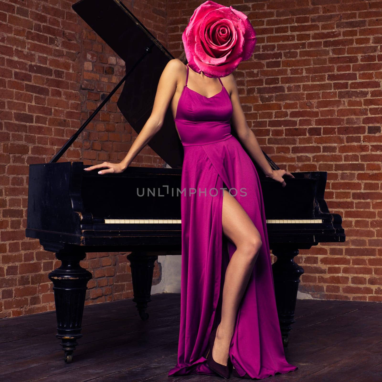 Abstract contemporary art collage sexy beautiful woman in long classic red dress posing with old piano with flower rose bud on face.