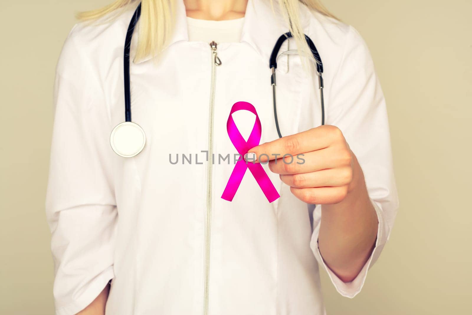 Female Doctor Holds Pink Ribbon, International Breast Cancer Day October 7 by zartarn